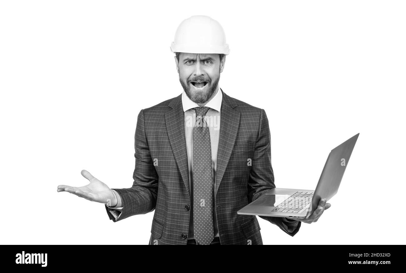 angry businessman man in suit and helmet hold computer isolated on white, anger Stock Photo