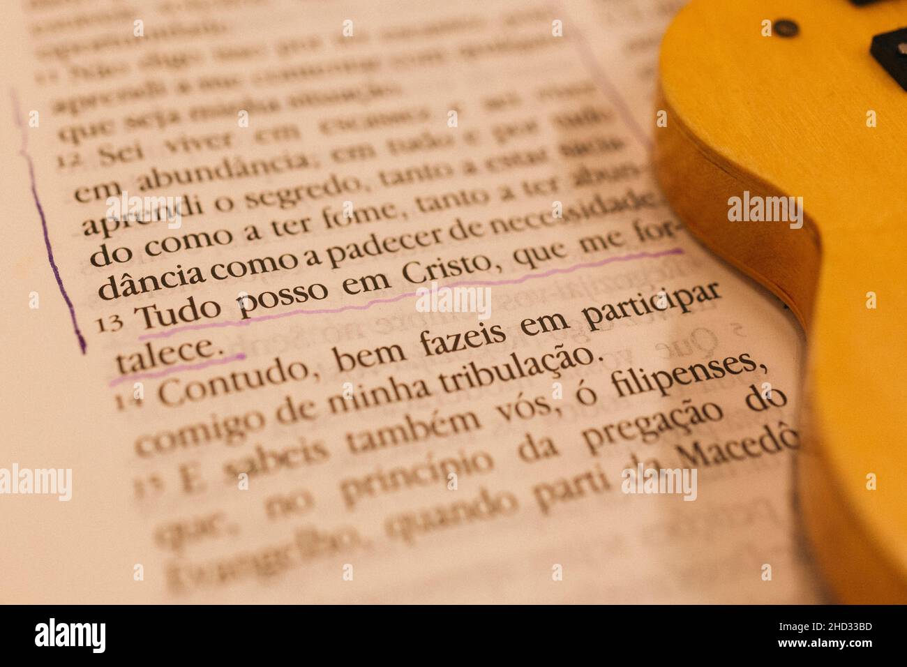 Close-up shot of the Portuguese Bible page and partly guitar Stock Photo