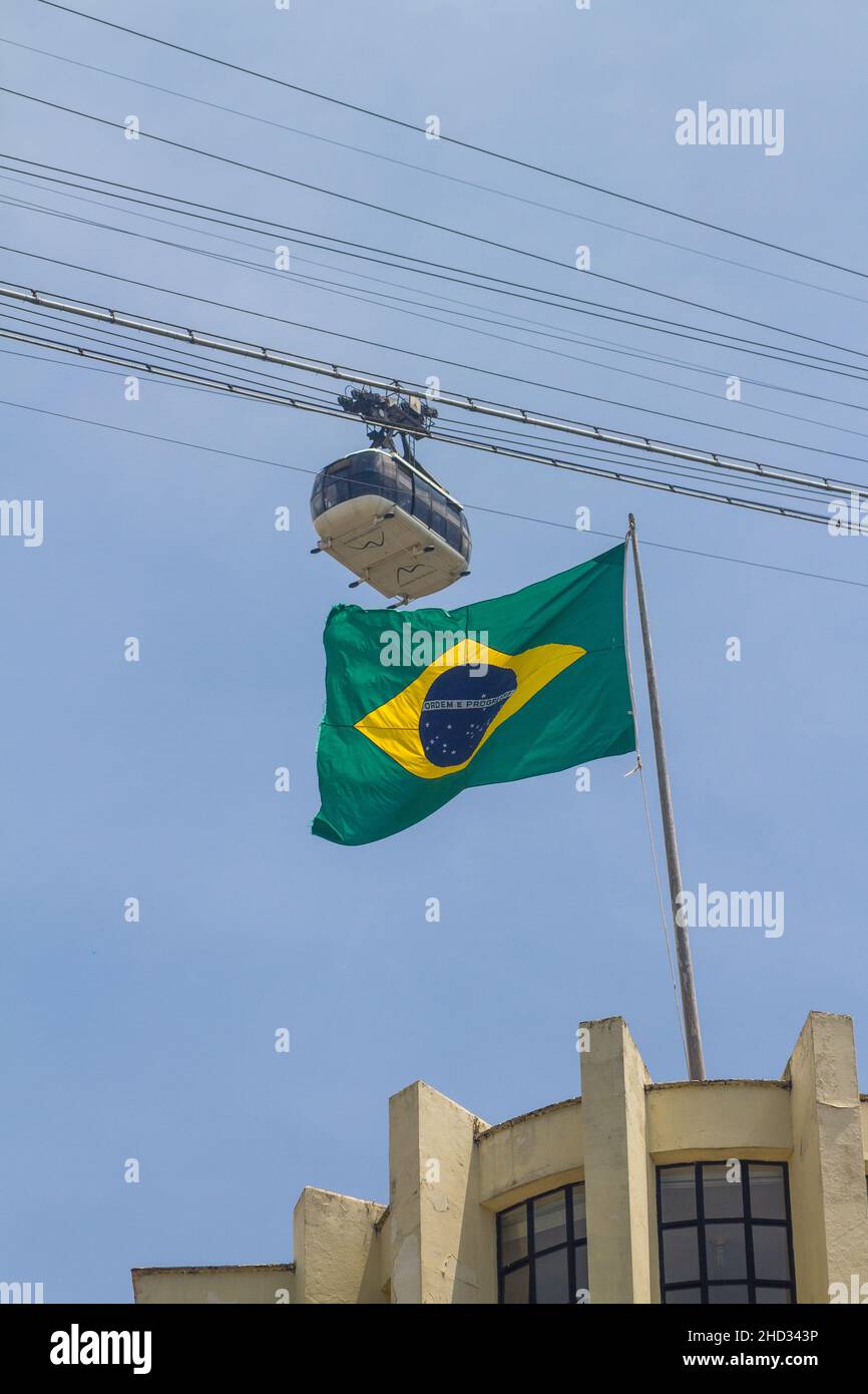 brazilian flag with Sugarloaf cable car in Rio de Janeiro, Brazil - October 23, 2021: brazil flag with sugarloaf cable car in the background in Rio de Stock Photo