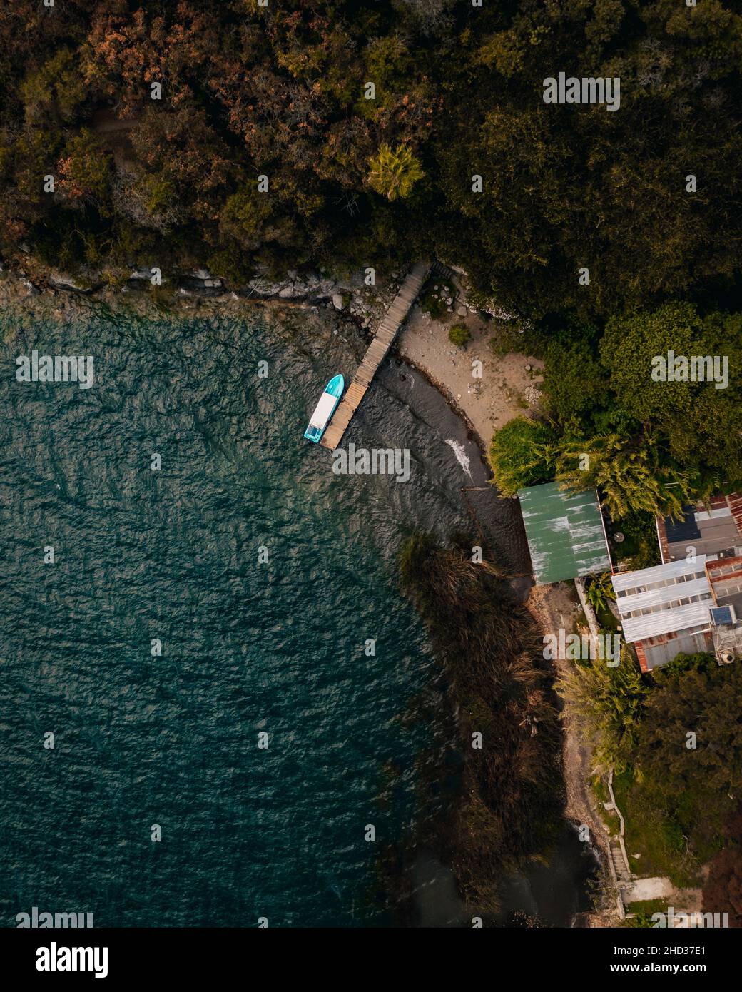Vertical aerial shot of a boat berthed at docks in Lake Atitlan in Guatemala, Central America Stock Photo
