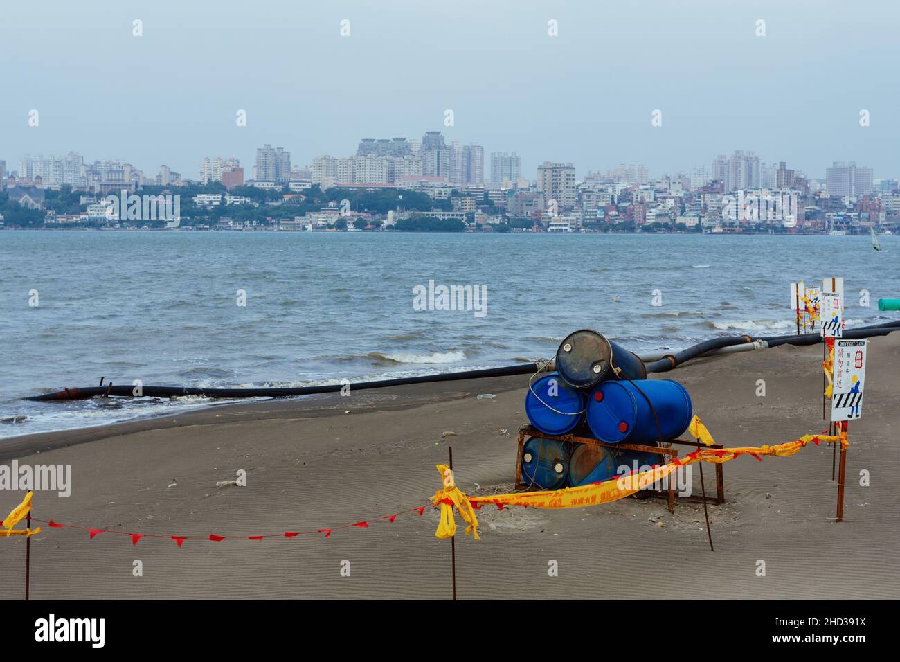 Taipei, Taiwan. 5 December, 2009. A general view shows caution tapes, barrels and pipes laying along the banks of Tamsui River in Bali District, Taipei, Taiwan. Stock Photo