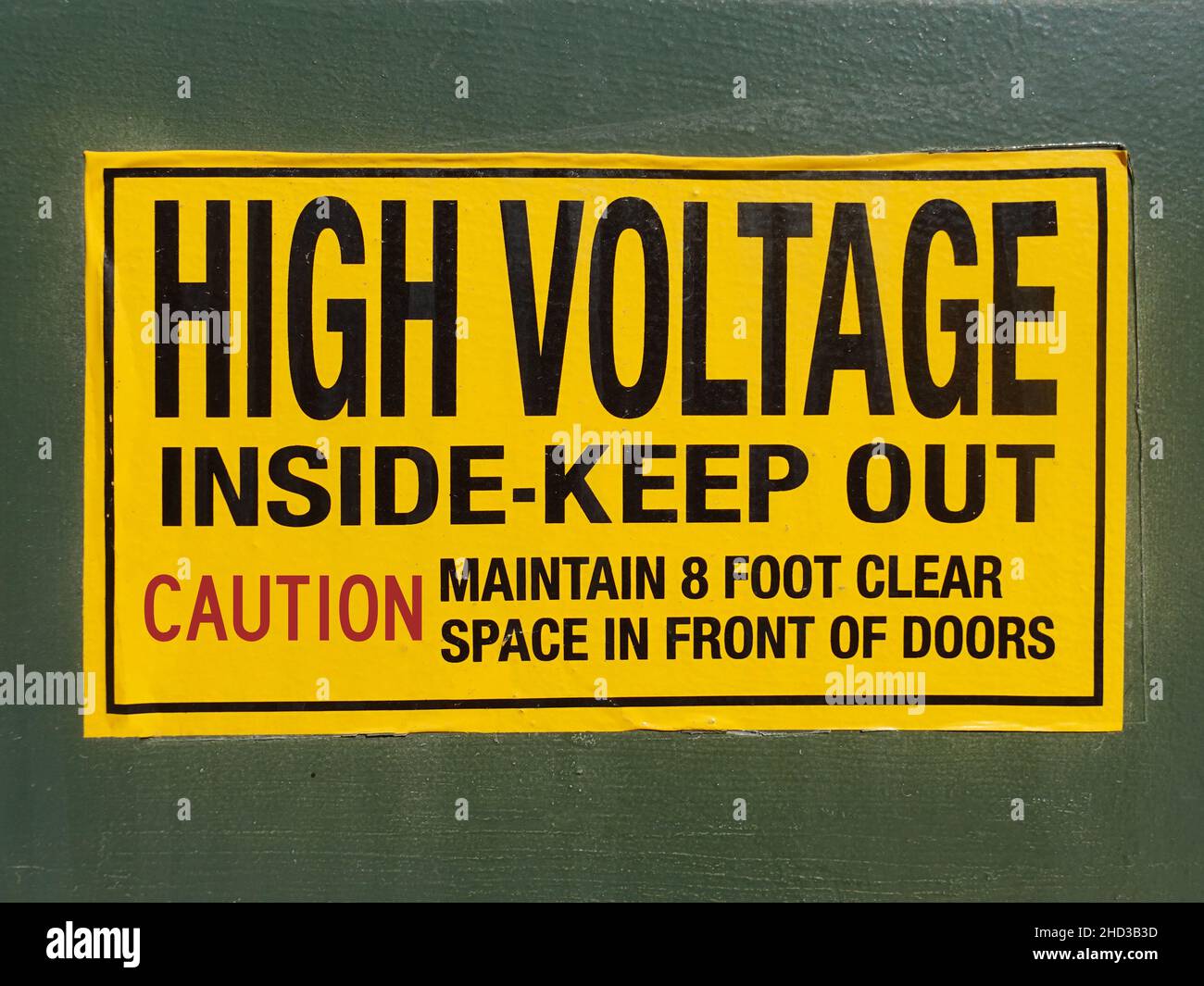 A Black on yellow high voltage warning sign on side of transformer vault. Stock Photo