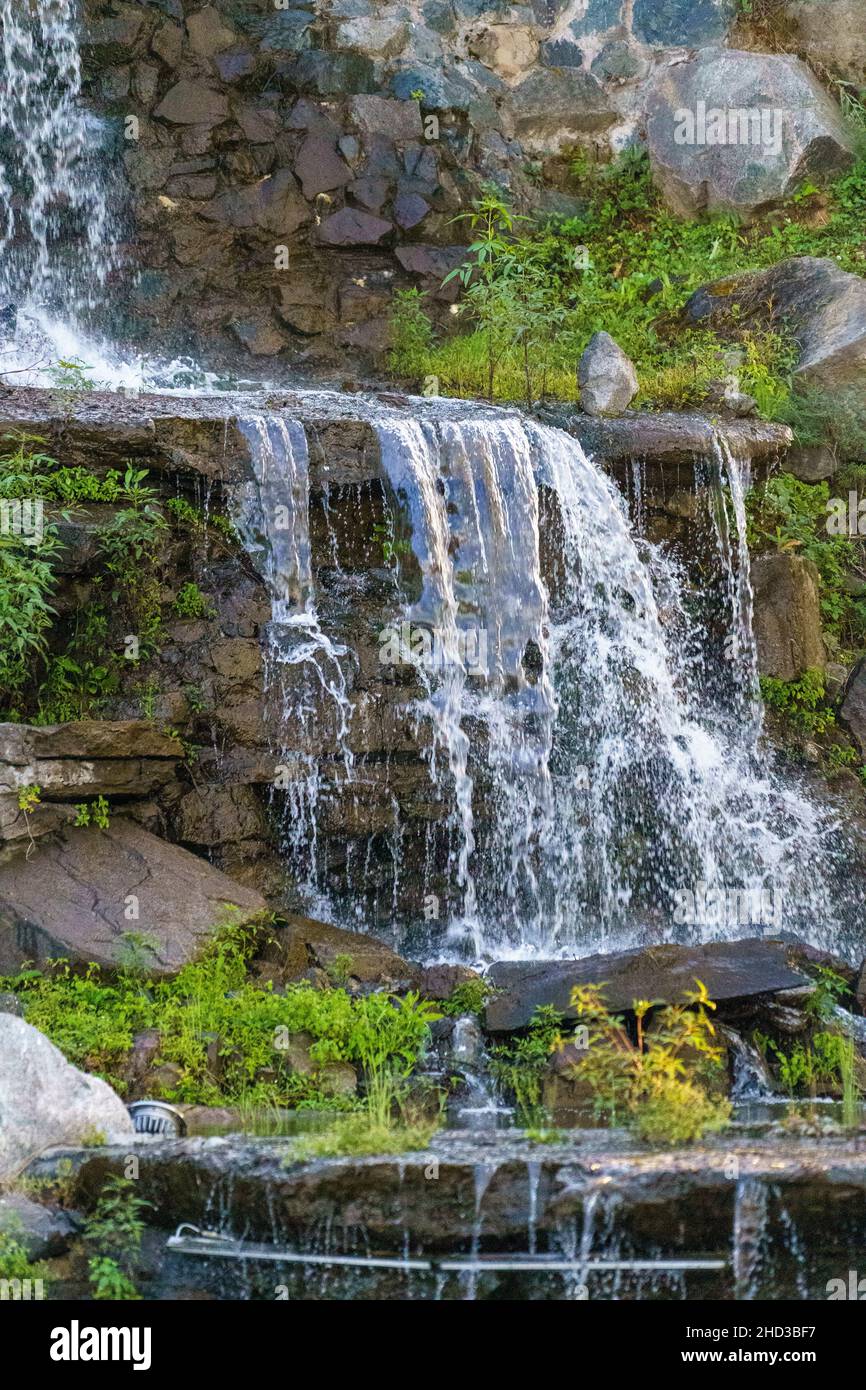 Landscape with an artificial waterfall in the park. Vladivostok, Russia Stock Photo