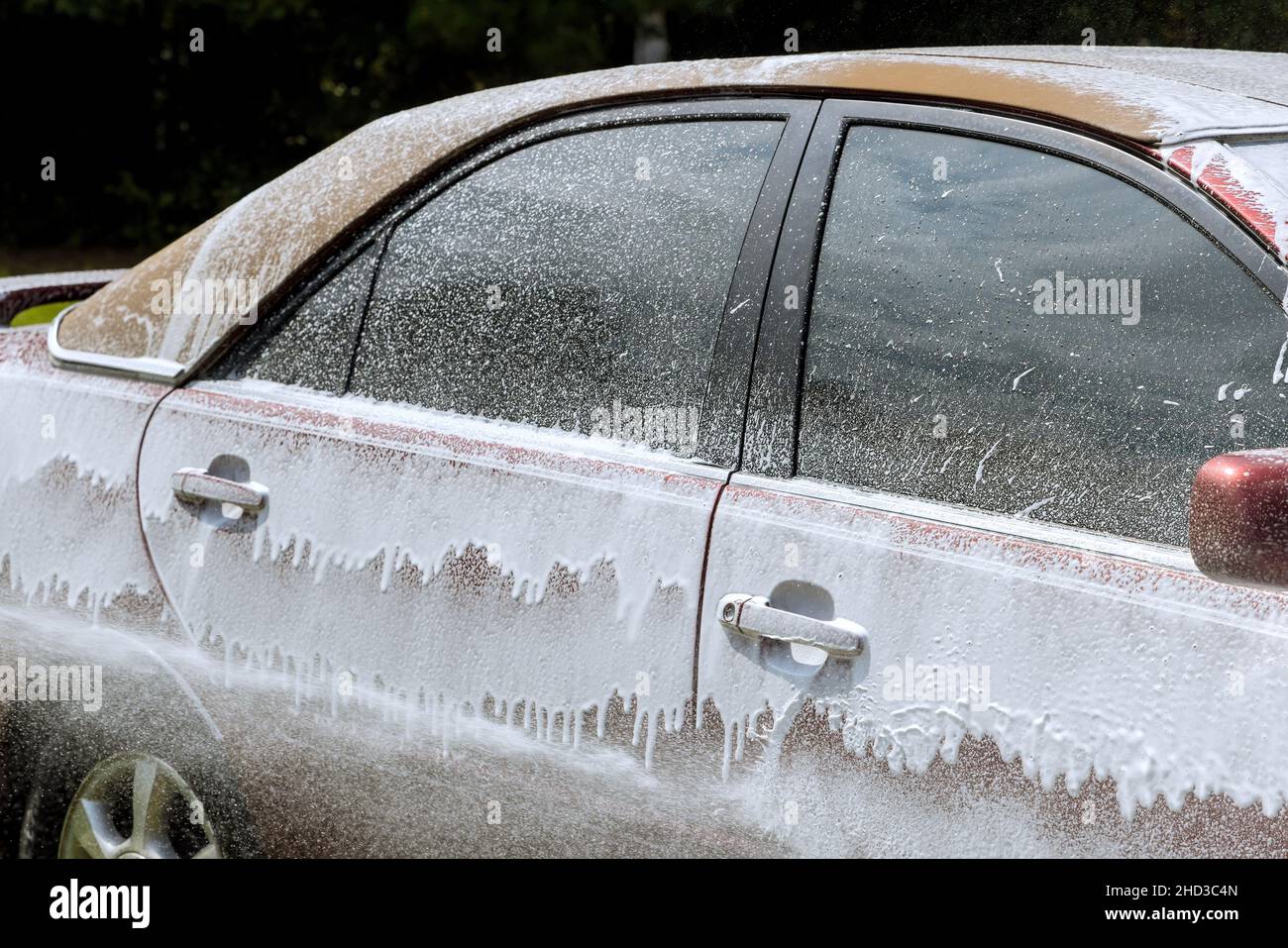 Cleaning the car with foam car wash in self service Stock Photo Alamy