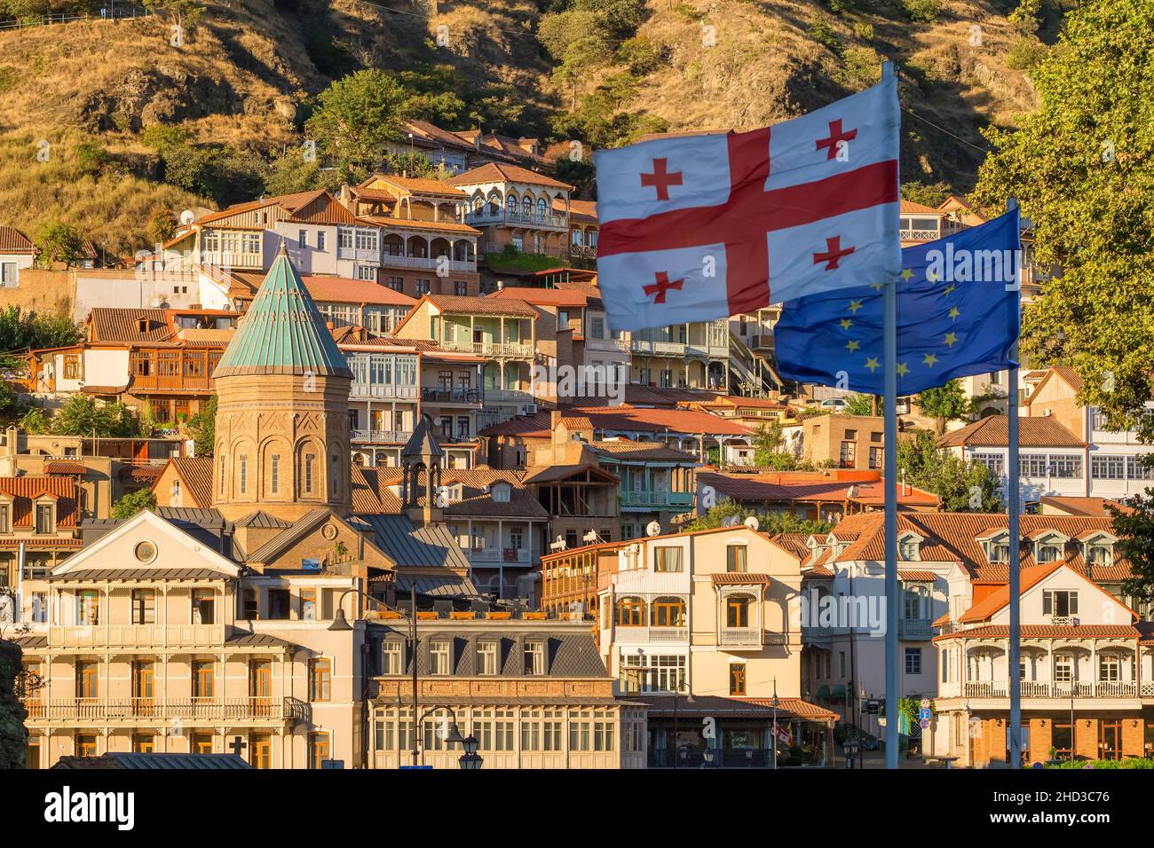 Georgian and European Union waving flags in Tbilisi old town, Georgiac Stock Photo