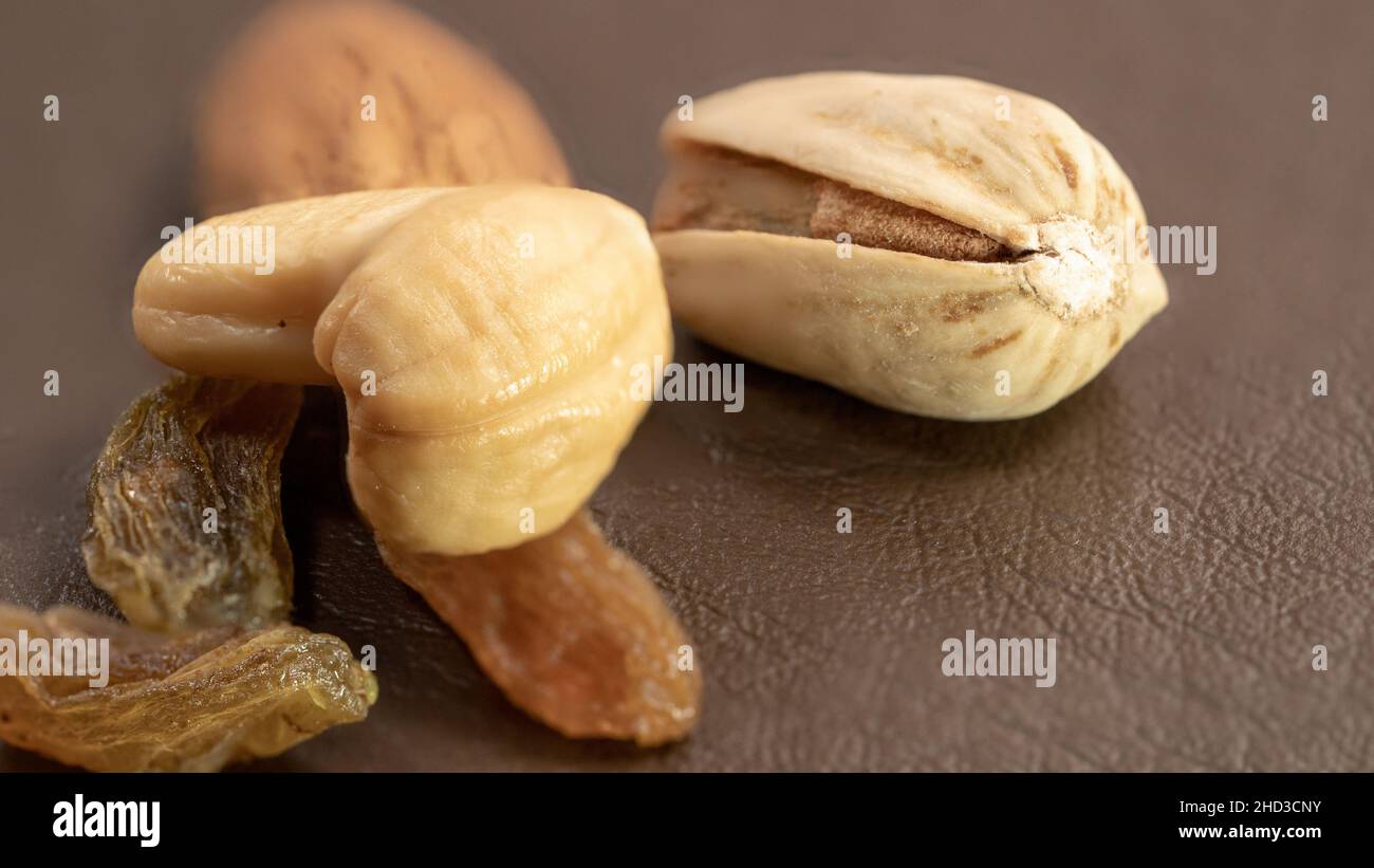 Close-up of Pistachios and Dried Apricots on Brown Background Stock Photo