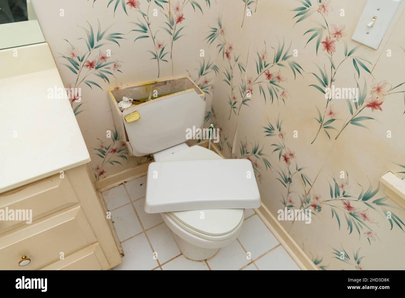 Broken toilet in bathroom in need of repair Stock Photo