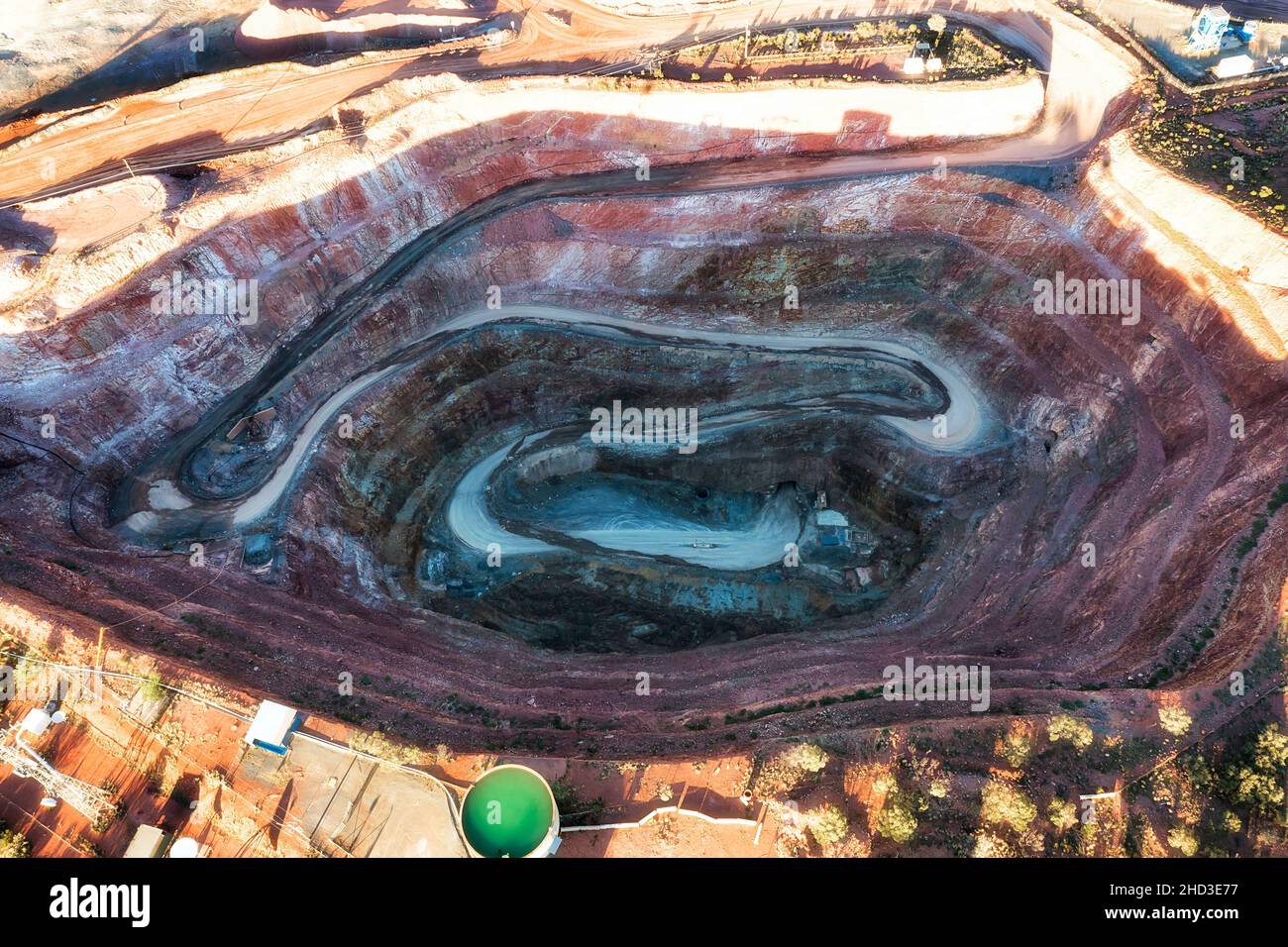 Round deep open pit copper mine in Cobar town of Australia - aerial view over mine opening. Stock Photo