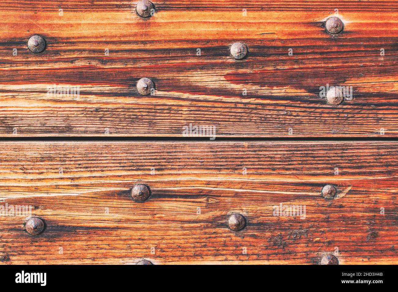 Detail of door made of wooden slats with big iron nails Stock Photo