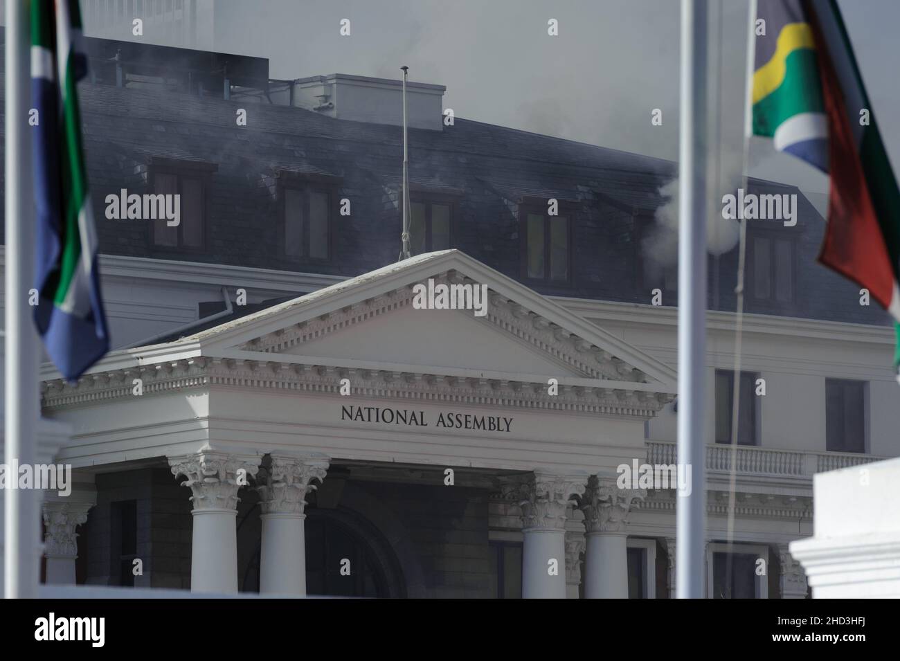South Africa's national parliament smouldering after a fire broke out in the early hours of 2 January 2022 in central Cape Town Stock Photo