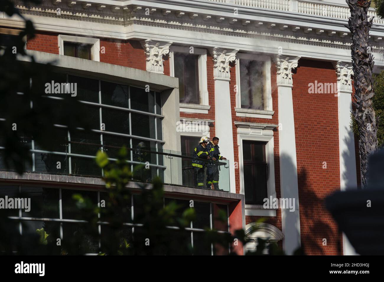 South Africa's national parliament smouldering after a fire broke out in the early hours of 2 January 2022 in central Cape Town Stock Photo