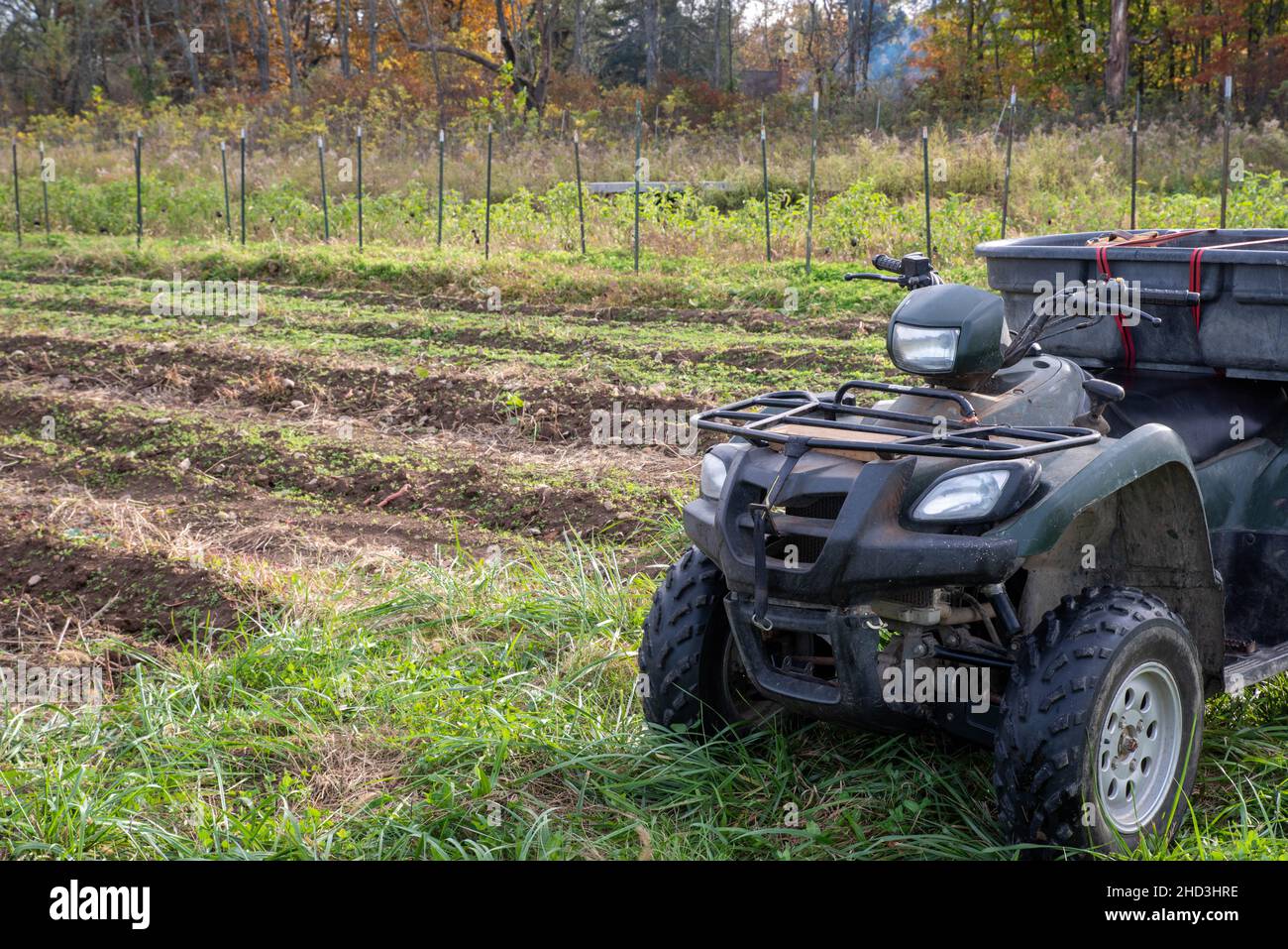 Off road vehicle by a vegetable garden with autumn trees background Stock Photo