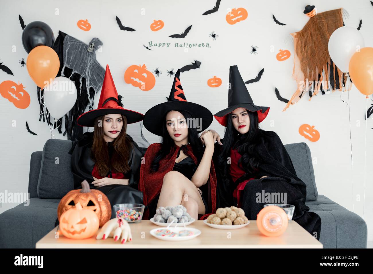 Gang of witch teen Thai women with celebrate Halloween party with smile in  the room at home. Concept of party Halloween at home. Group young Asian wo Stock Photo