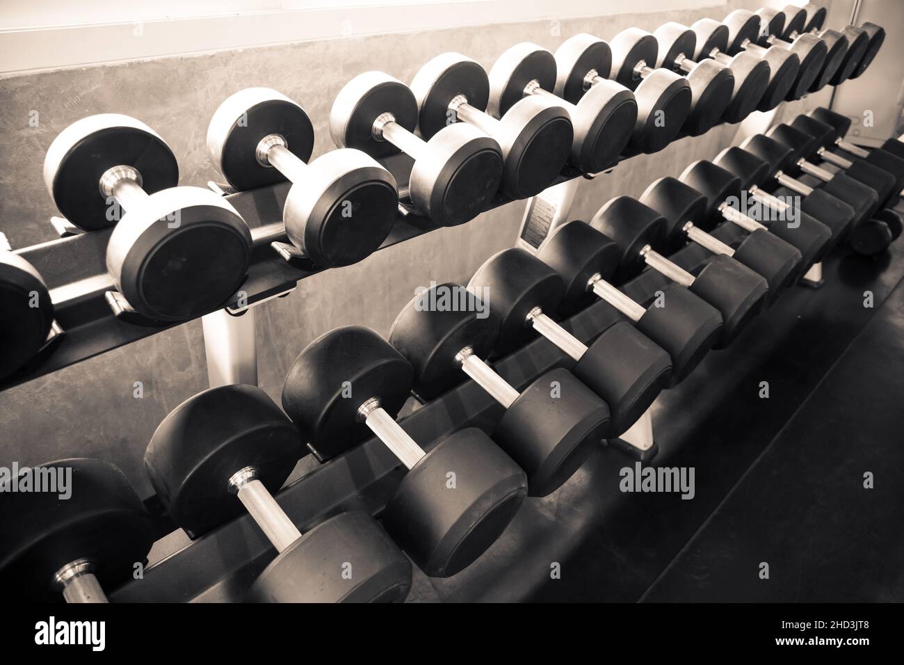 Dumbbells are on the shelves of the gym. Modern of gym interior with equipment. Sports equipment in the gym. Stock Photo