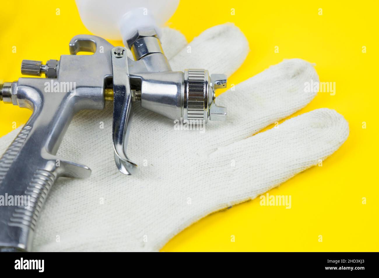 Instructions and a paint spray gun at work at the workplace in the