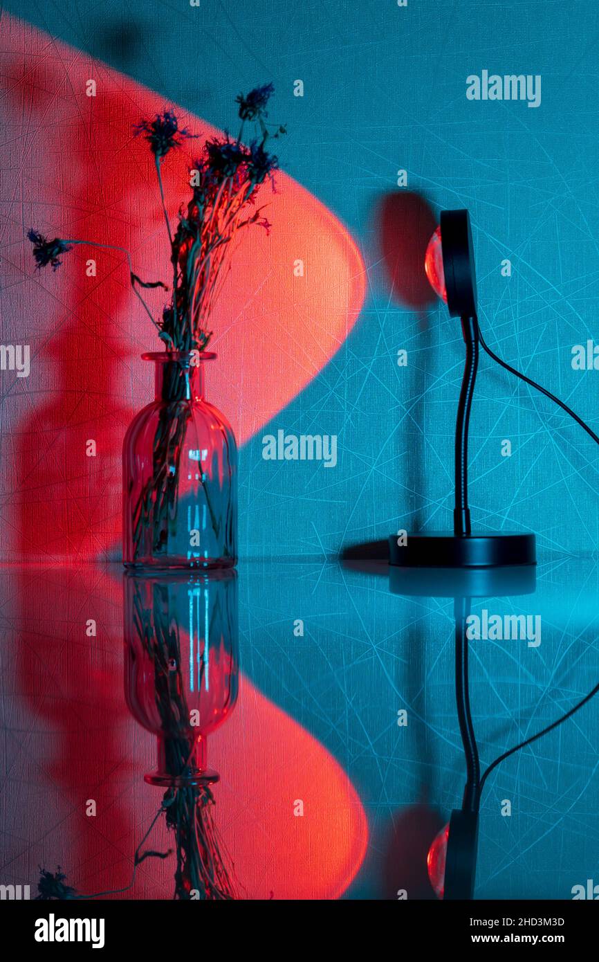 Sunset projector lamp on the table. Multi colored RGB light. Home decor. Selective focus Stock Photo