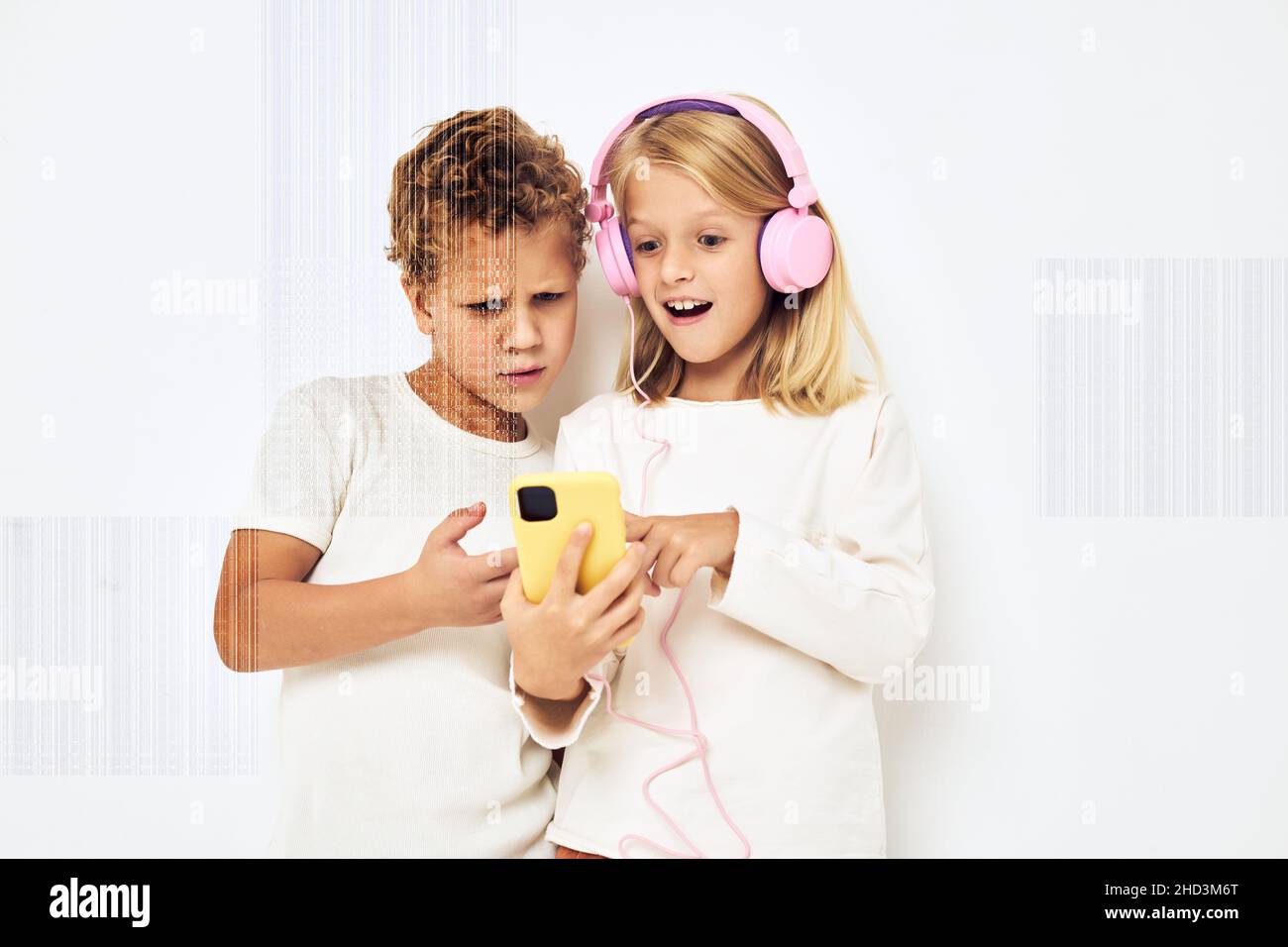 Image of boy and girl looking at the phone posing lifestyle childhood