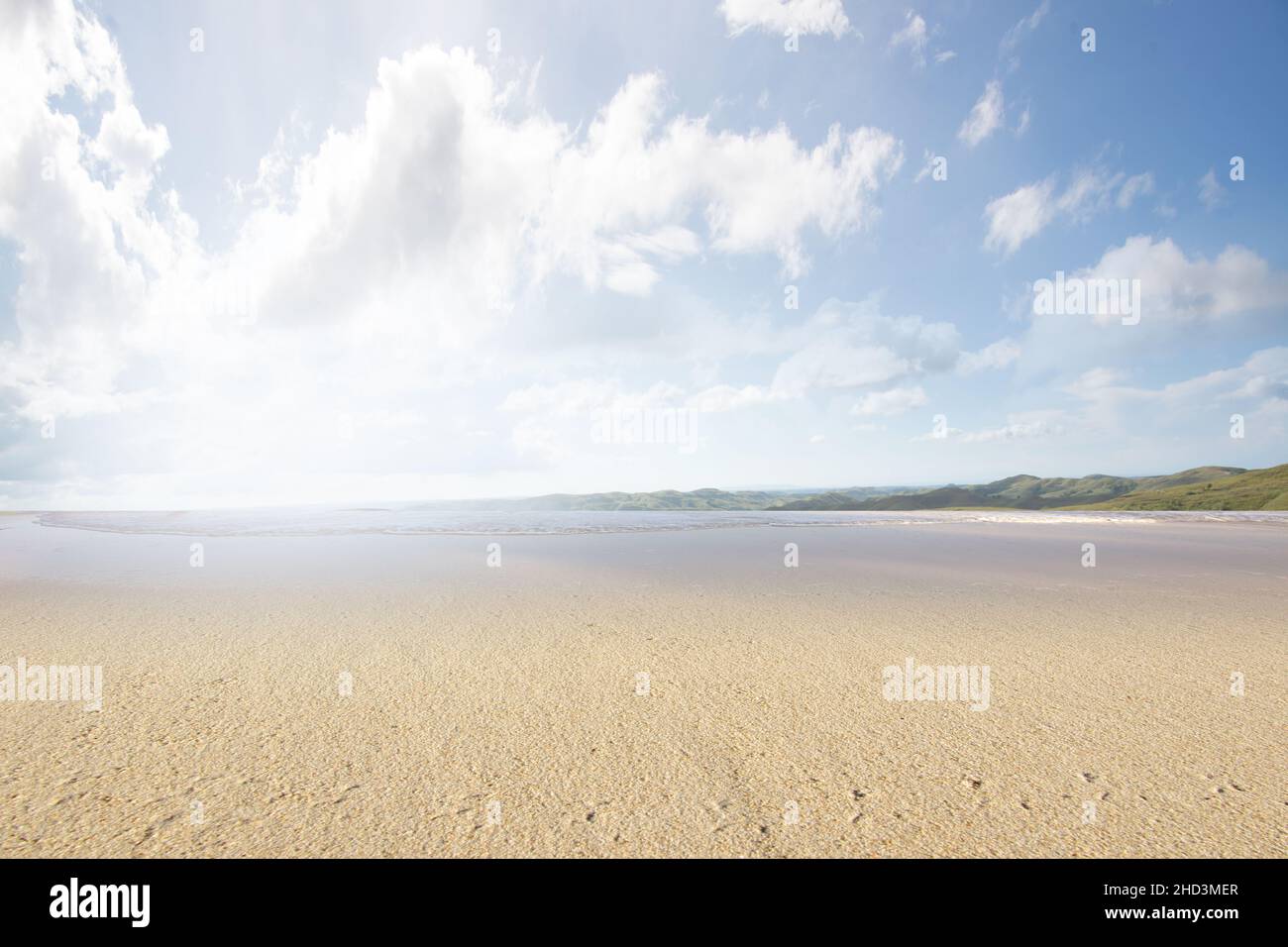 Sandy beach with the blue ocean and blue sky background Stock Photo - Alamy