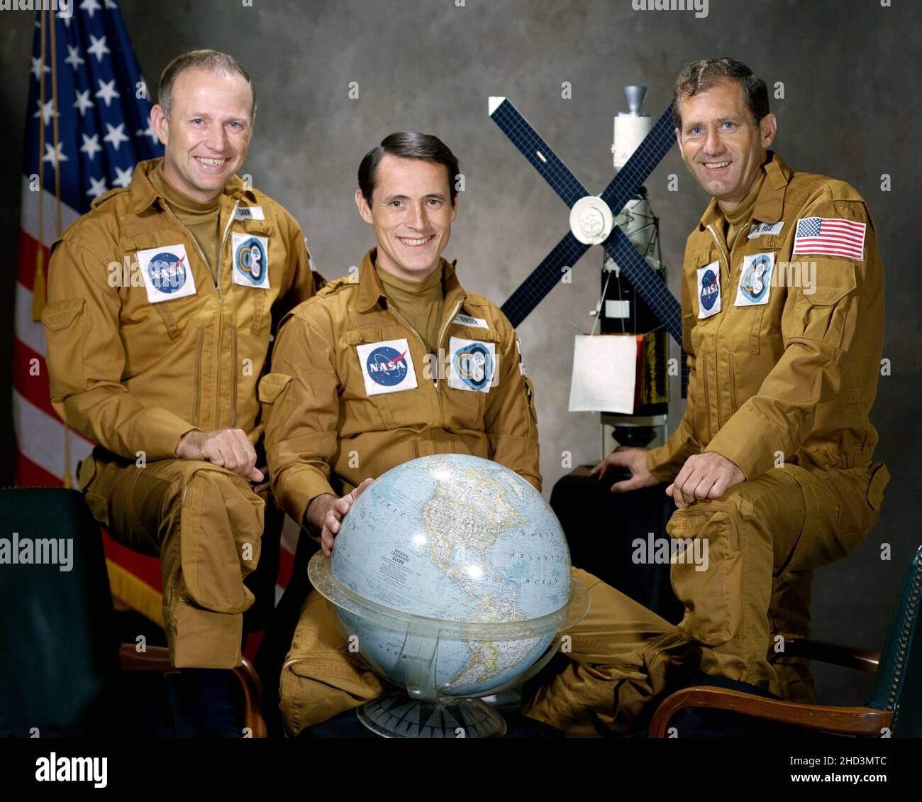 (August 1973) --- These three men are the prime crewmen for the Skylab 4 mission. Pictured in their flight suits with a globe and a model of the Skylab space station are, left to right, astronaut Gerald P. Carr, commander; scientist-astronaut Edward G. Gibson, science pilot; and astronaut William R. Pogue, pilot. Stock Photo