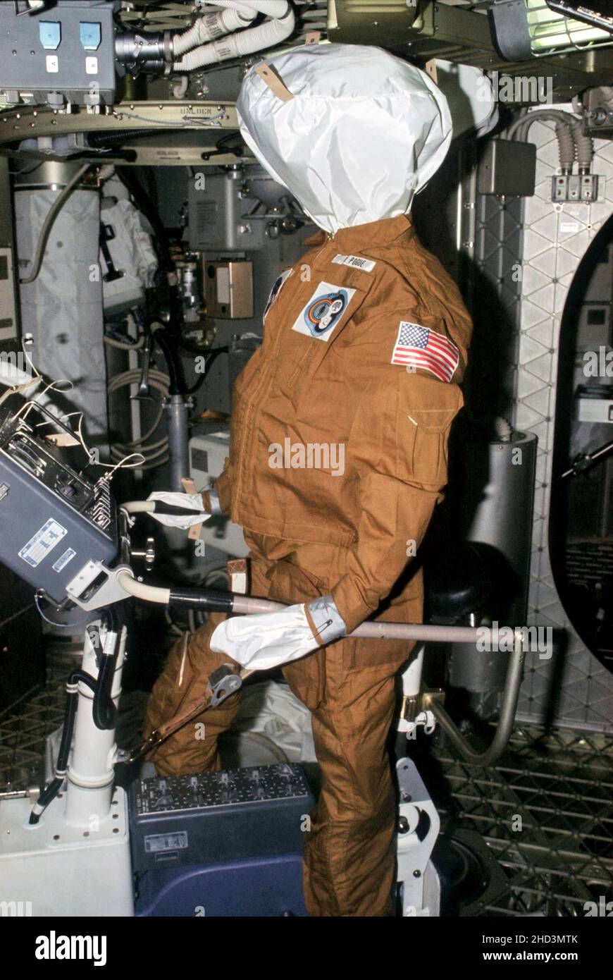 (July-September 1973) --- This photograph is an illustration of the humorous side of the Skylab 3 crew. This dummy was left behind in the Skylab space station by the Skylab 3 crew to be found by the Skylab 4 crew. The dummy is dressed in a flight suit and propped upon the bicycle ergometer. The name tag indicated that it represents William R. Pogue, Skylab pilot. The dummy for Gerald P. Carr, Skylab 4 commander, was placed in the Lower Body Negative Pressure Device. The dummy representing Edward G. Gibson was left in the waste compartment. Astronauts Alan L. Bean, Owen K. Garriott and Jack R. Stock Photo