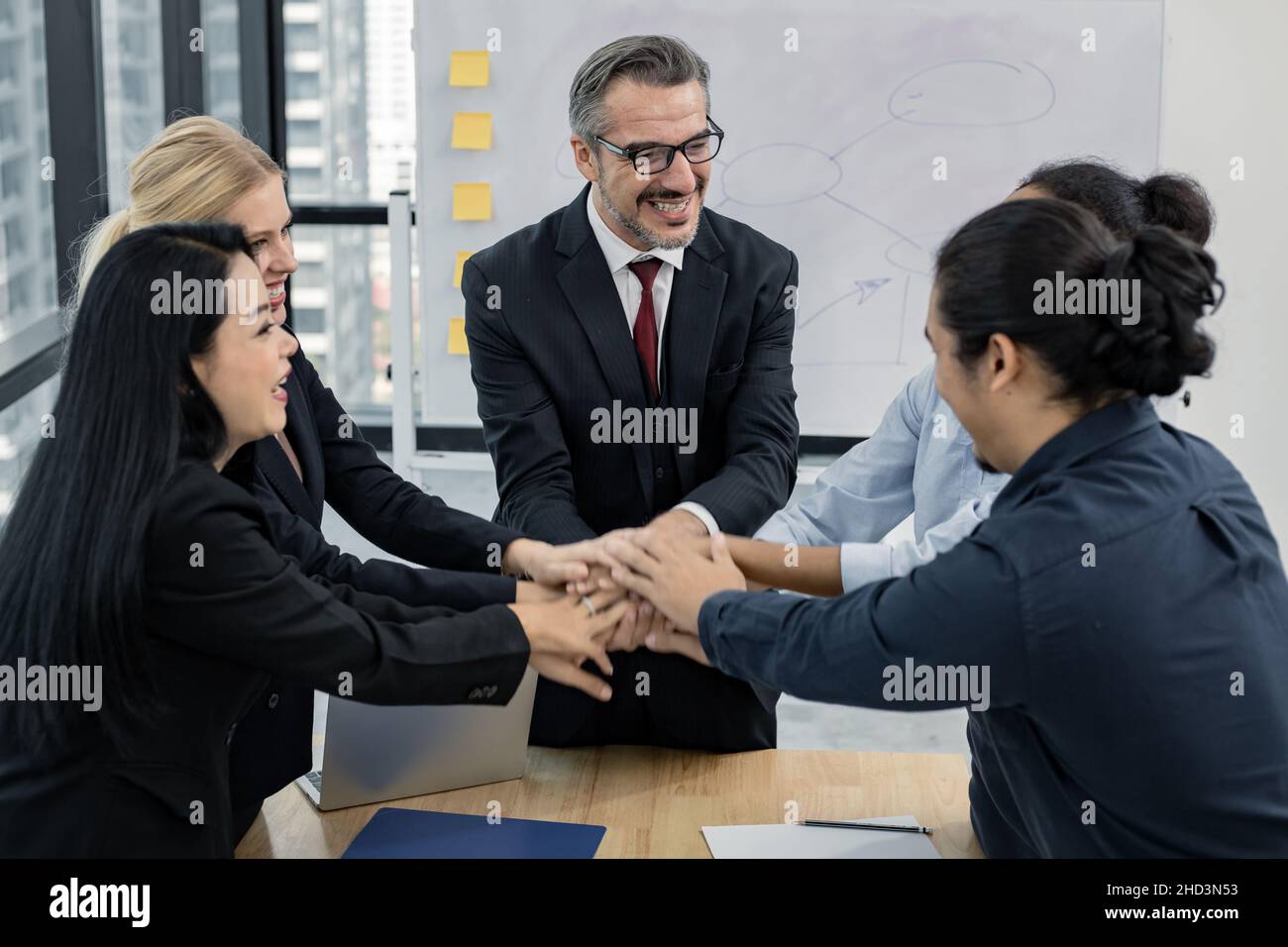 Business team showing unity with their hands together. Success business team concept. Business people putting their hands together. Stock Photo