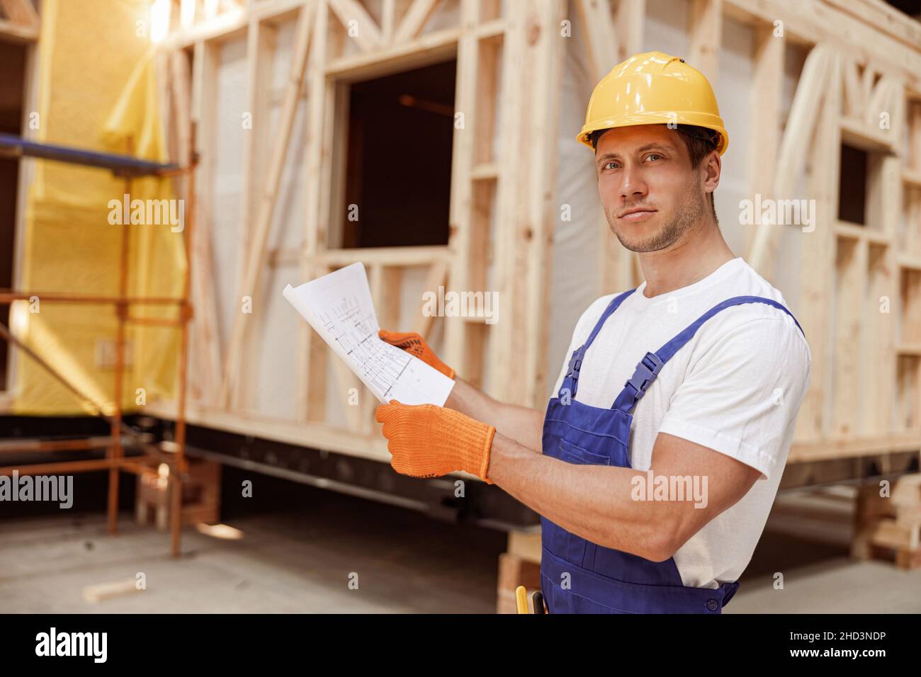 Handsome man studying architectural plan at construction site Stock Photo