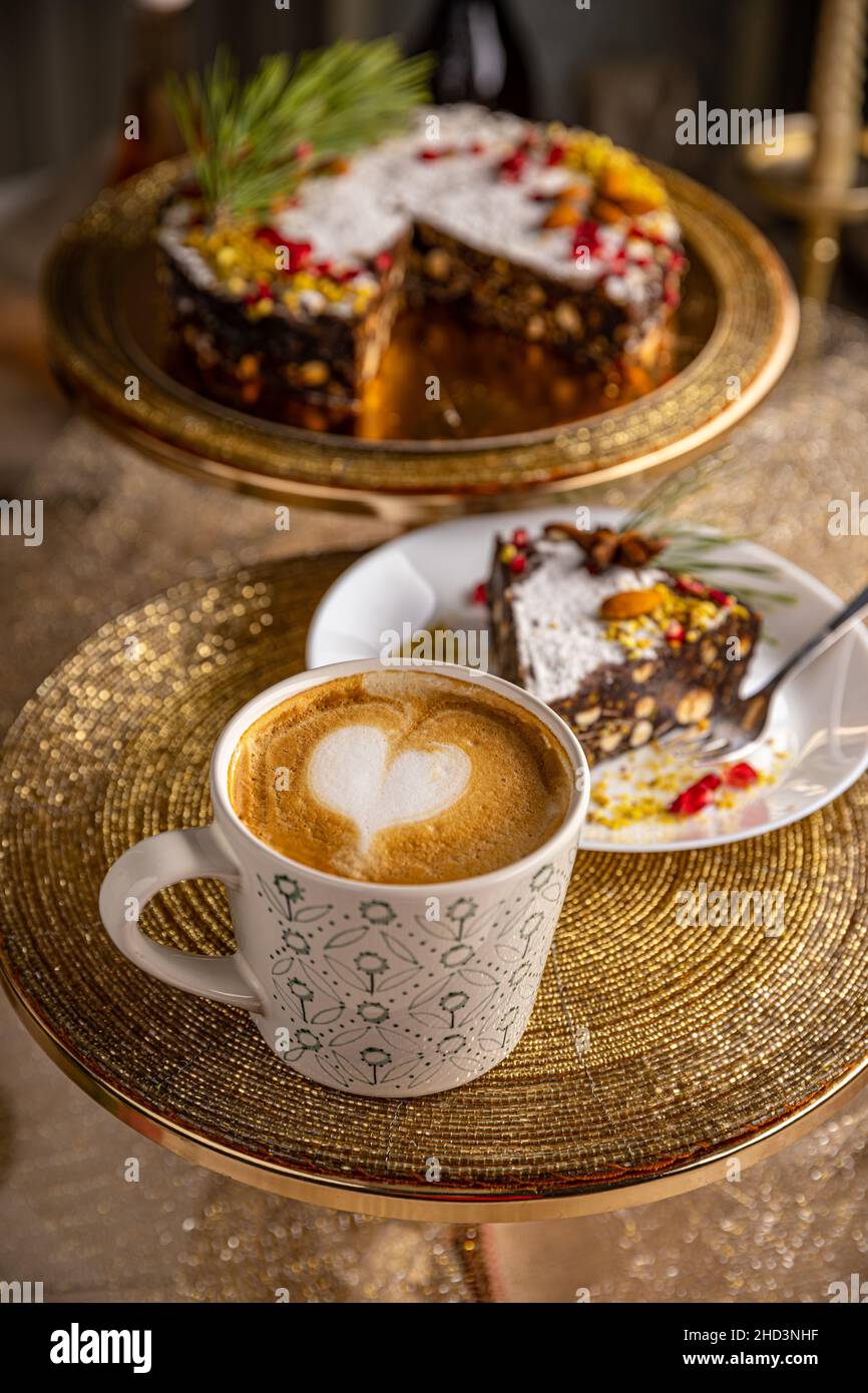 Mug of coffee latte served with raw vegan chocolate cake Stock Photo