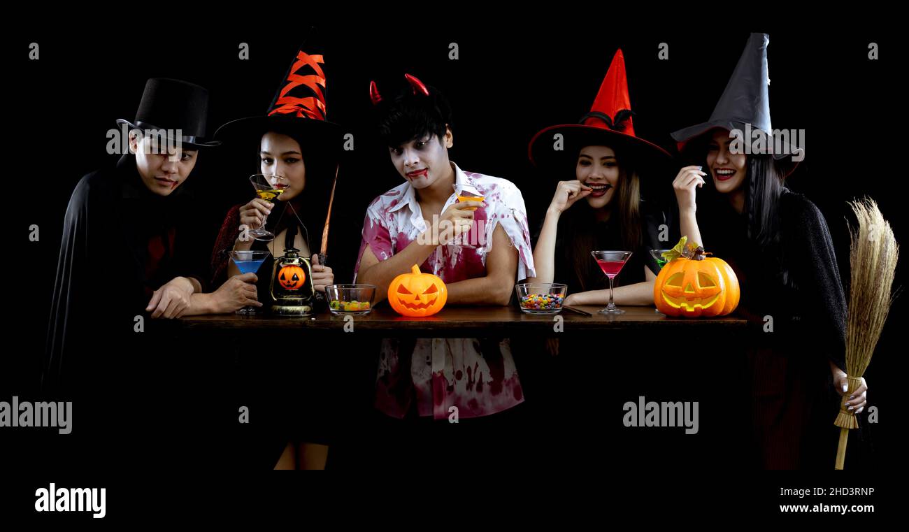 Group young Asian in costume celebrate Halloween party on black background with concept for Halloween fashion festival. Gang of teen Asian in cosplay Stock Photo