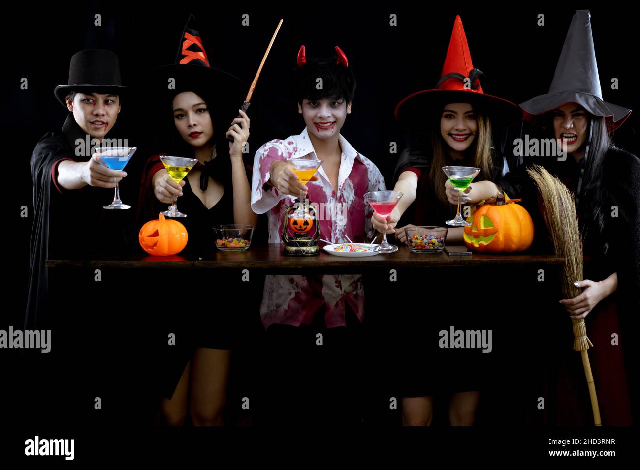 Group young Asian in costume celebrate Halloween party on black background with concept for Halloween fashion festival. Gang of teen Asian in cosplay Stock Photo