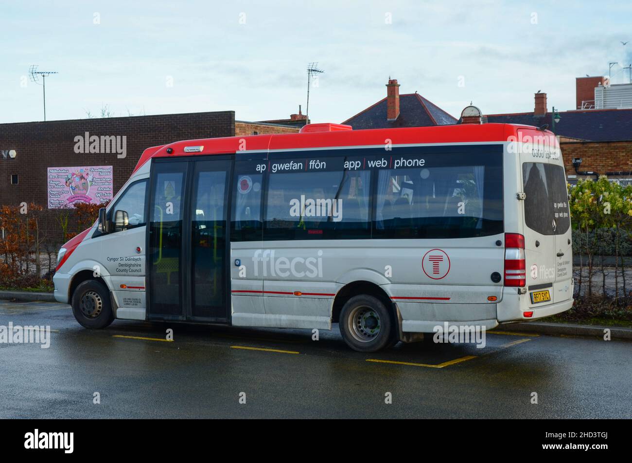 Prestatyn, UK: Dec 14, 2021: An accessible minibus parked at the bus station is being operated on behalf of TFW. It is operating a demand responsive l Stock Photo