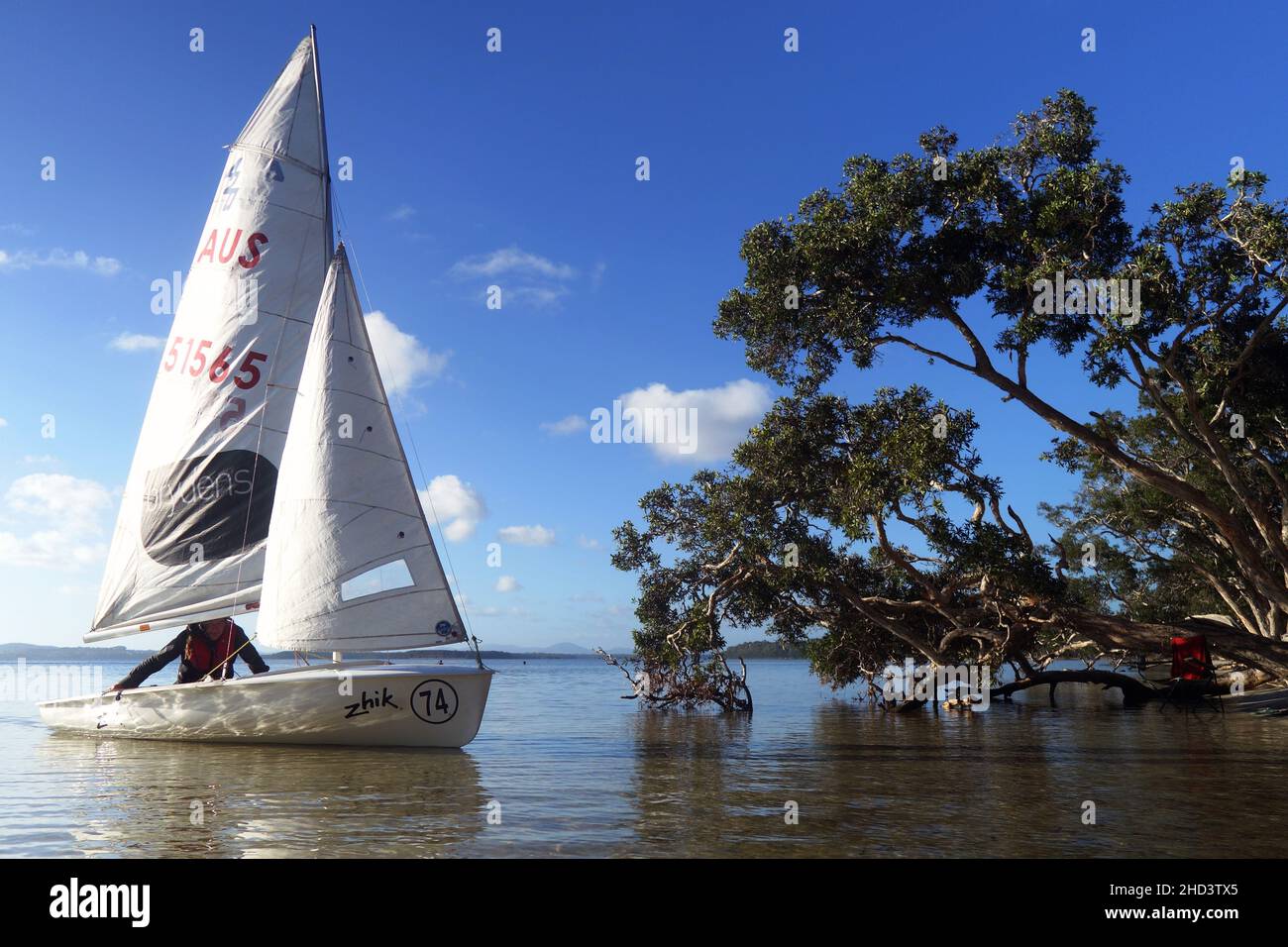 Dinghy sailor on Wallis Lake, NSW, Australia. No MR or PR Stock Photo