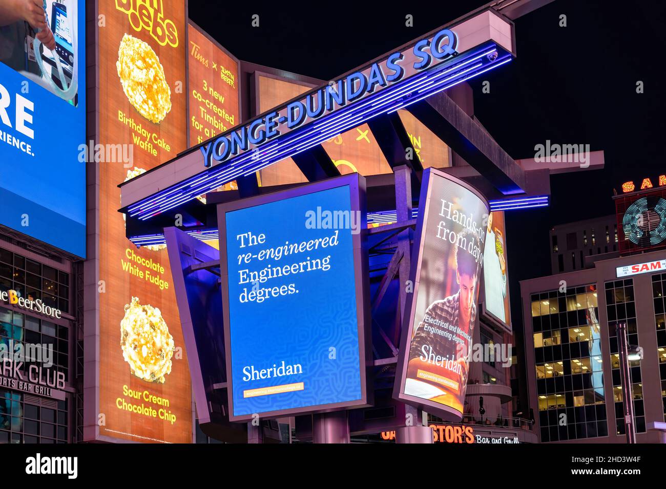 An advertisement of Sheridan college in Yonge-Dundas square at night. The place is a tourist attraction in the city. Jan. 3, 2022 Stock Photo