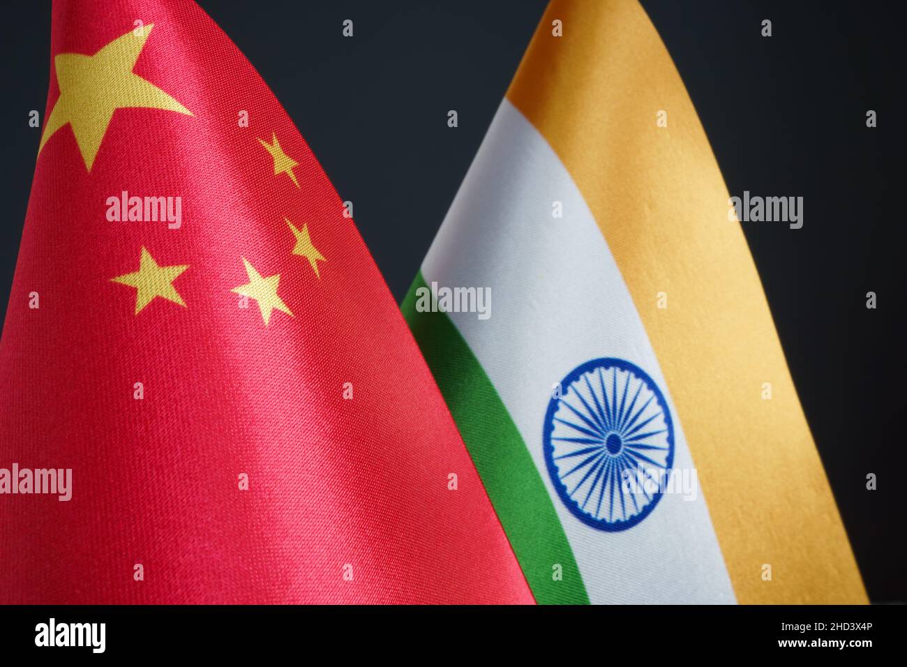 Flags of China and India in the dark. Stock Photo