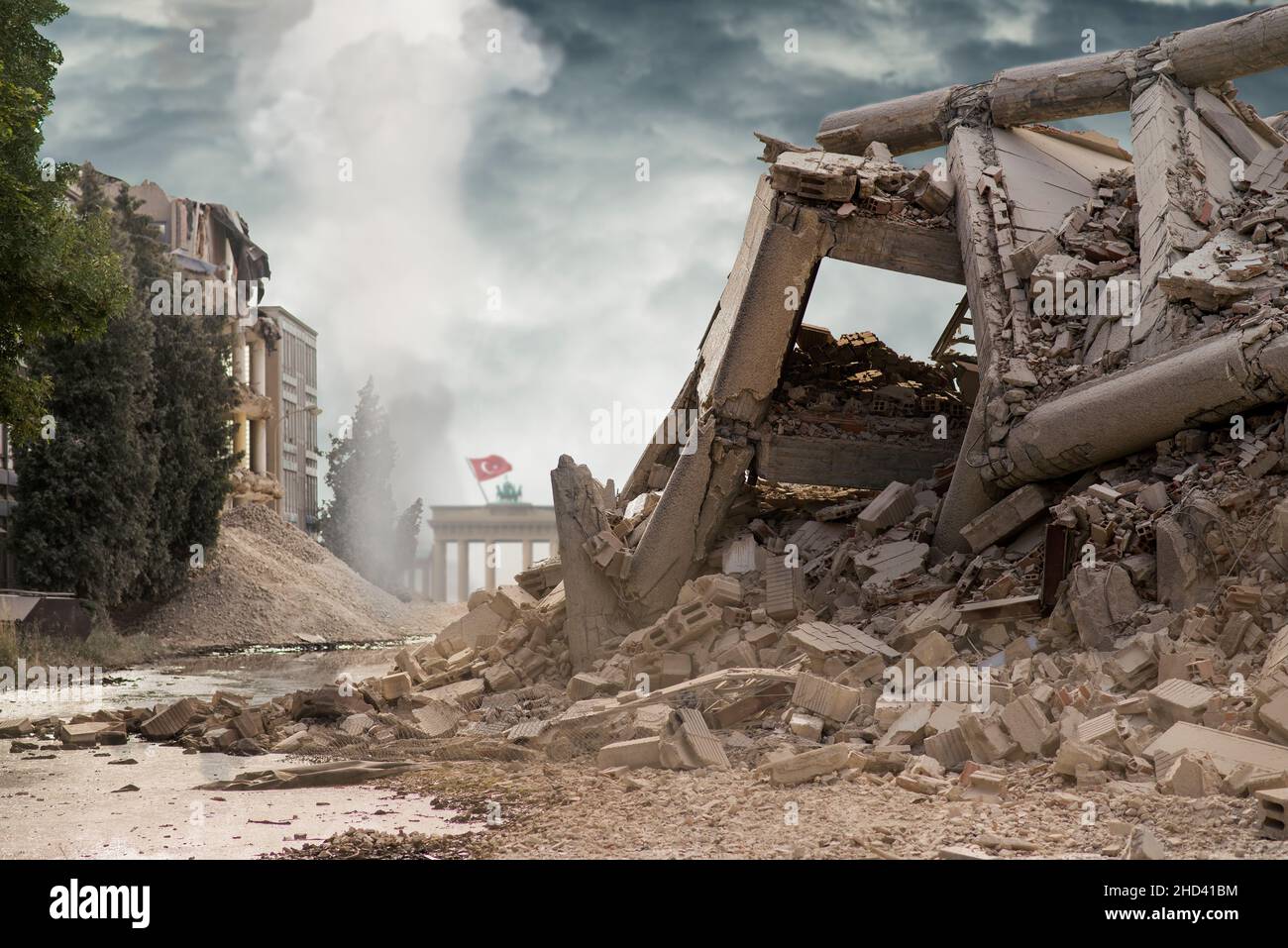 View on a collapsed concrete industrial building with German Brandenburg gate behind and Turkish flag above. Dark dramatic sky above. Damaged house. S Stock Photo