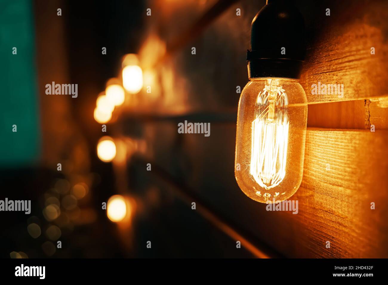 Antique incandescent Edison type bulb on wooden wall Stock Photo Alamy