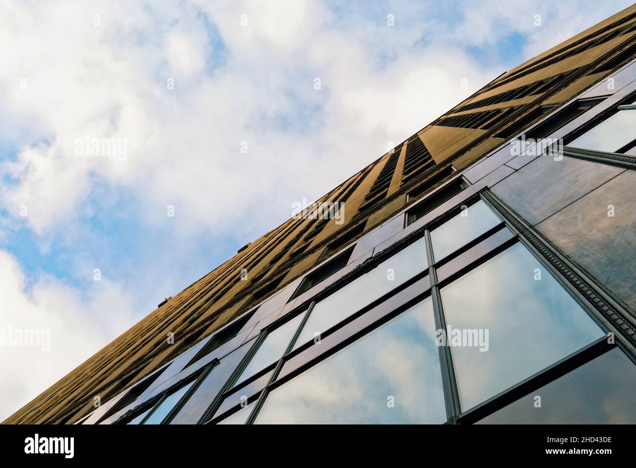 Exterior view of a building with glass windows in Chicago on cloudy sky