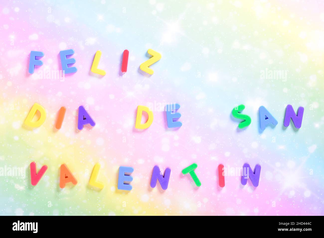 Photograph of some magnet letters with the text in Spanish of Happy Valentine's Day on a colored card.The photograph is shot in horizontal format and Stock Photo