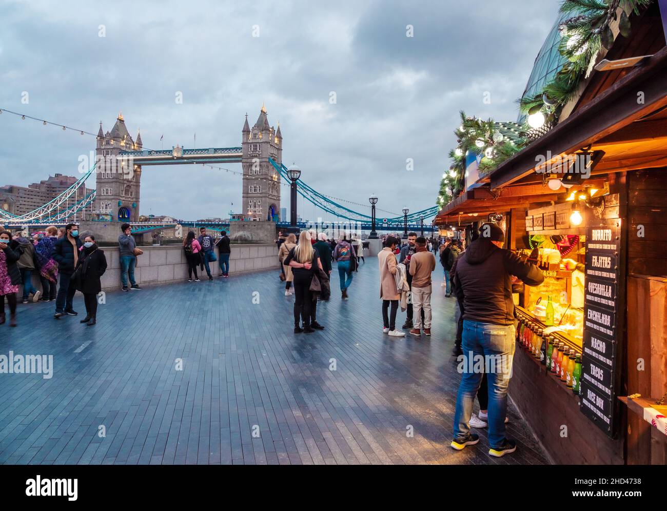 London, England, UK - December 31, 2021: Christmas market near the historical landmark Tower Bridge, view from the More London Riverside Stock Photo