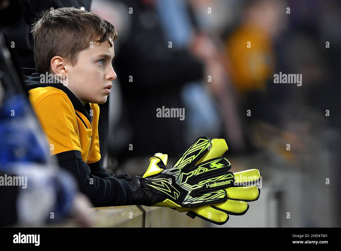 A young Wolverhampton Wanderers fan is seen wearing large goalkeepers gloves - Brighton & Hove Albion v Wolverhampton Wanderers, Premier League, Amex Stadium, Brighton, UK - 15th December 2021  Editorial Use Only - DataCo restrictions apply Stock Photo