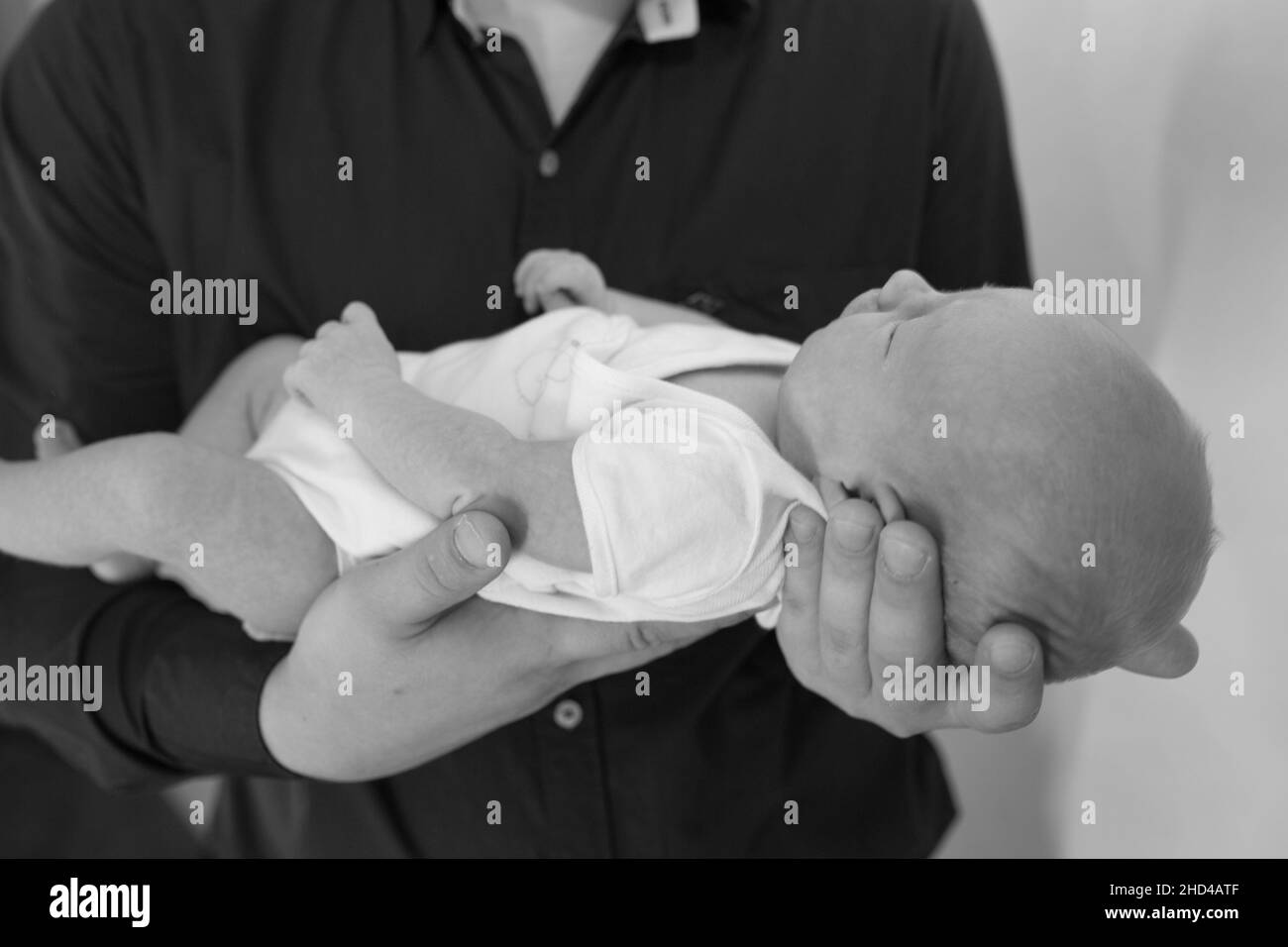 The father holds the newborn baby in his arms. Happy fatherhood concept. Father's day. Stock Photo