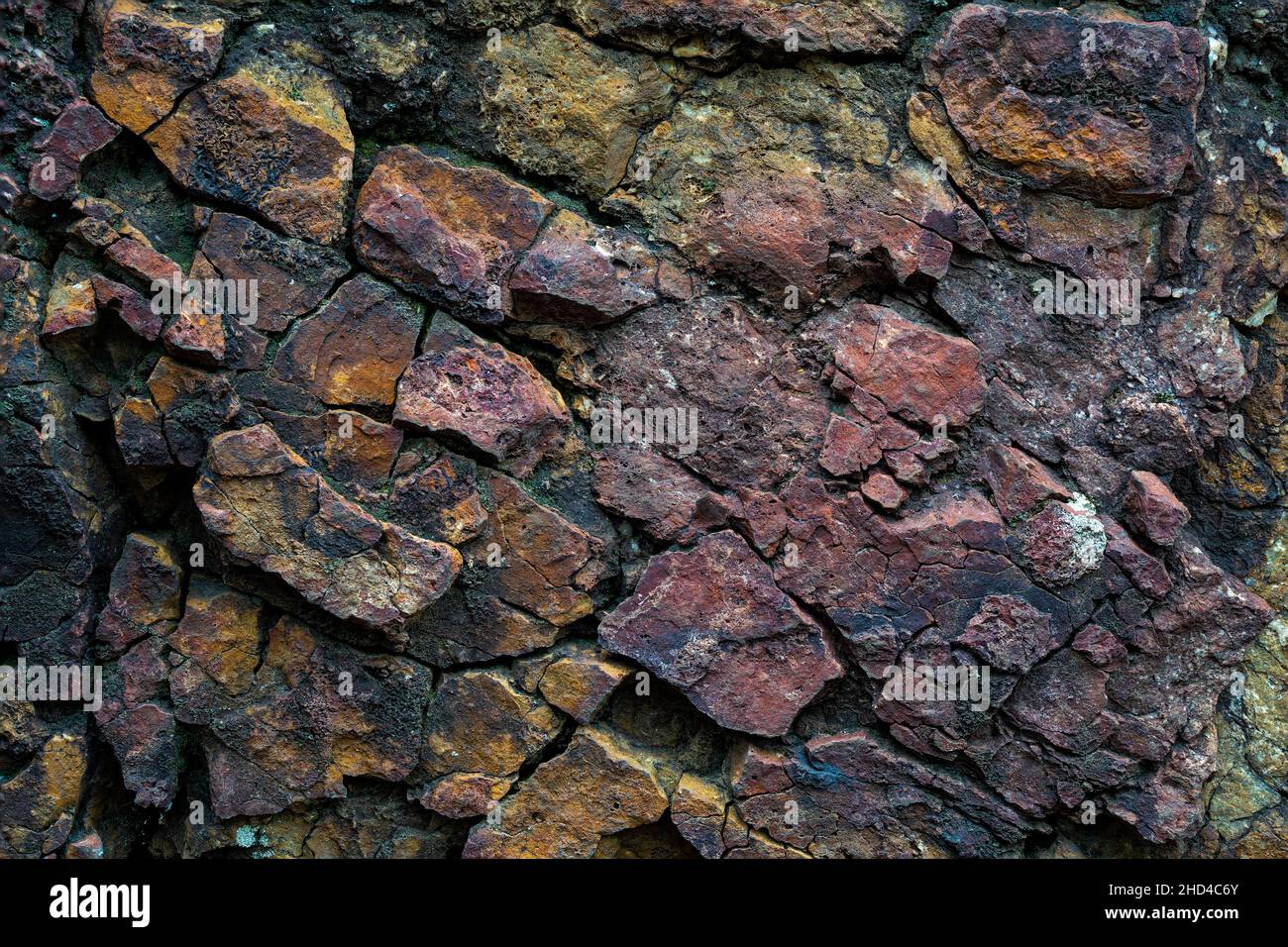 Cracked and  textured stone photo with yellow and magenta colored. Seamless and rough rock texture and pattern design. Stock Photo