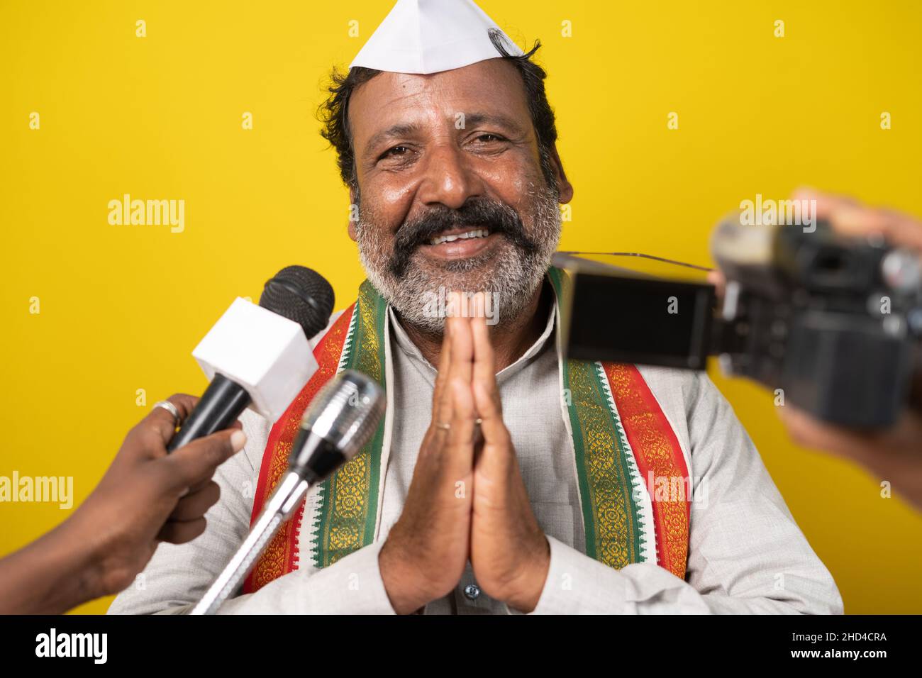 Political person greeting or doing namaste to people through media by looking camera - Concept of interviewing politician or announcement about Stock Photo
