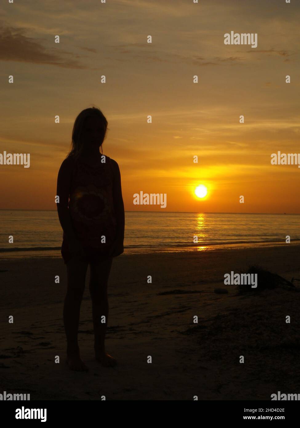 People's silhouette at sunset over Lido Beach Stock Photo