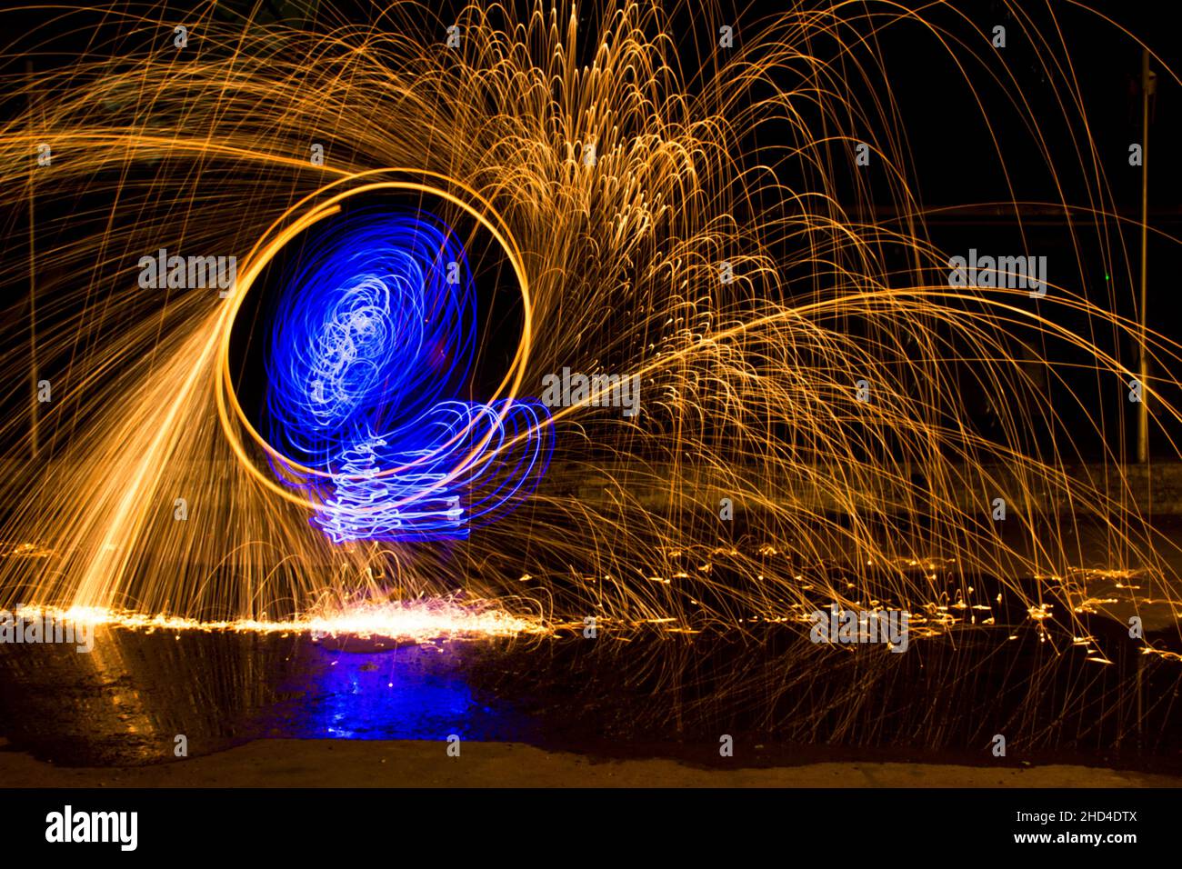 Beautiful, vibrant gold and blue circular wire wool in long exposure at