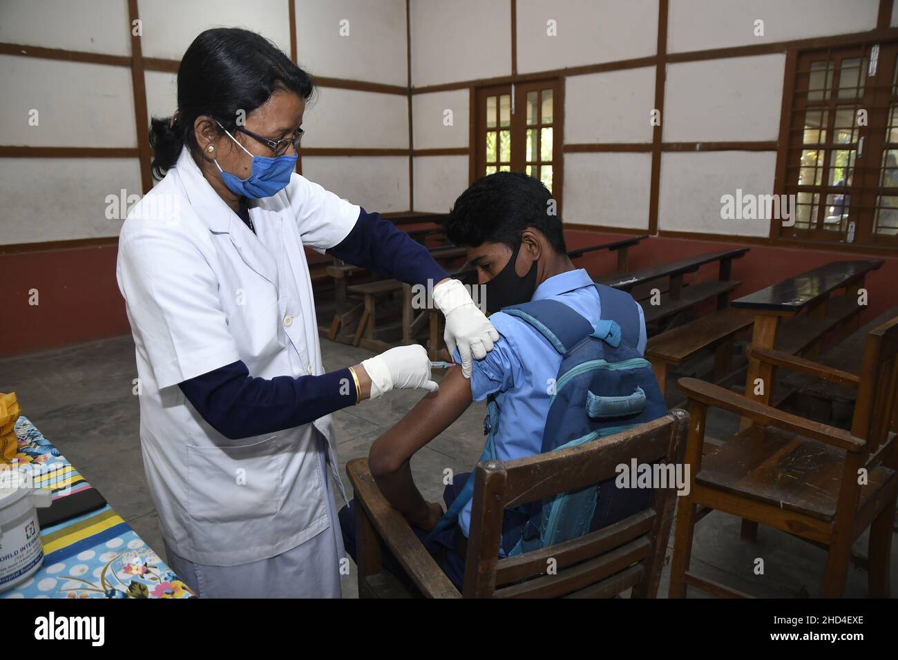 Nagaon. 3rd Jan, 2022. A boy receives a dose of COVID-19 vaccine at a school in Nagaon district of India's northeastern state of Assam, Jan. 3, 2022. India on Monday morning started vaccinating children aged 15 to 18 against COVID-19 amid fears of a surge in infections of the Omicron variant. Credit: Str/Xinhua/Alamy Live News Stock Photo