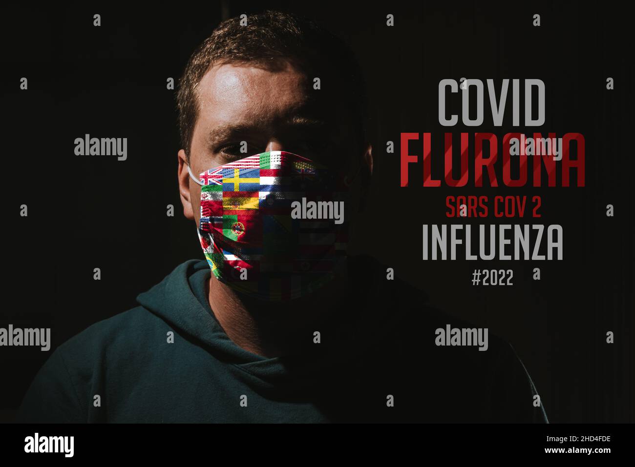 Man with world flags mask for virus protection with text Flurona corona virus covid-19 Stock Photo