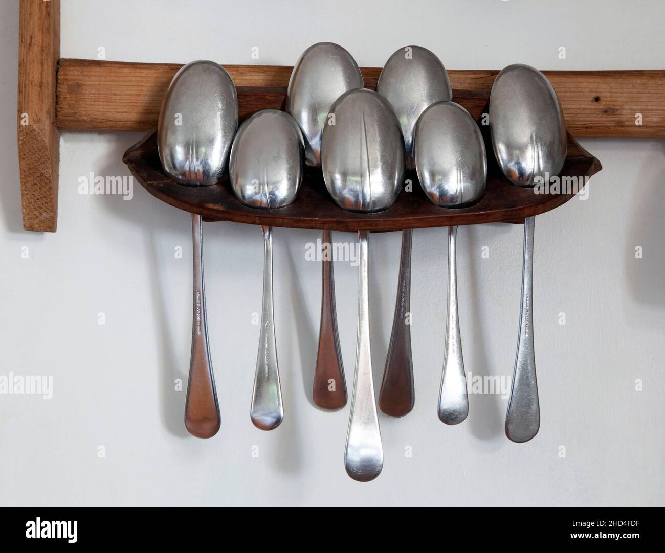 Antique spoon rack in country kitchen Stock Photo