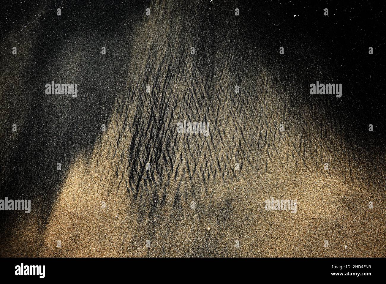 Black volcanic sand abstract pattern. Stock Photo