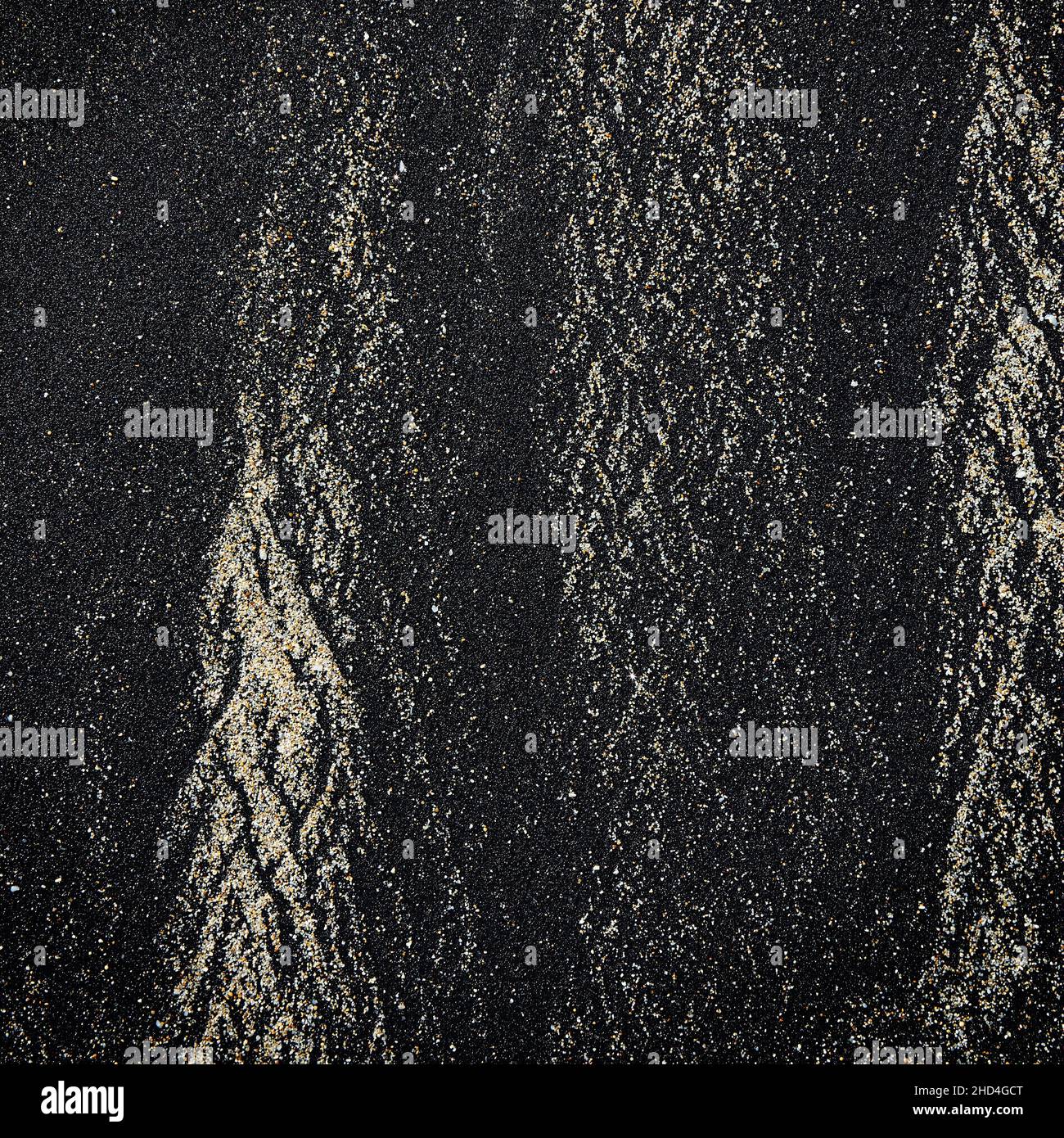 Abstract pattern made by waves on volcanic black sand of Bali island ...