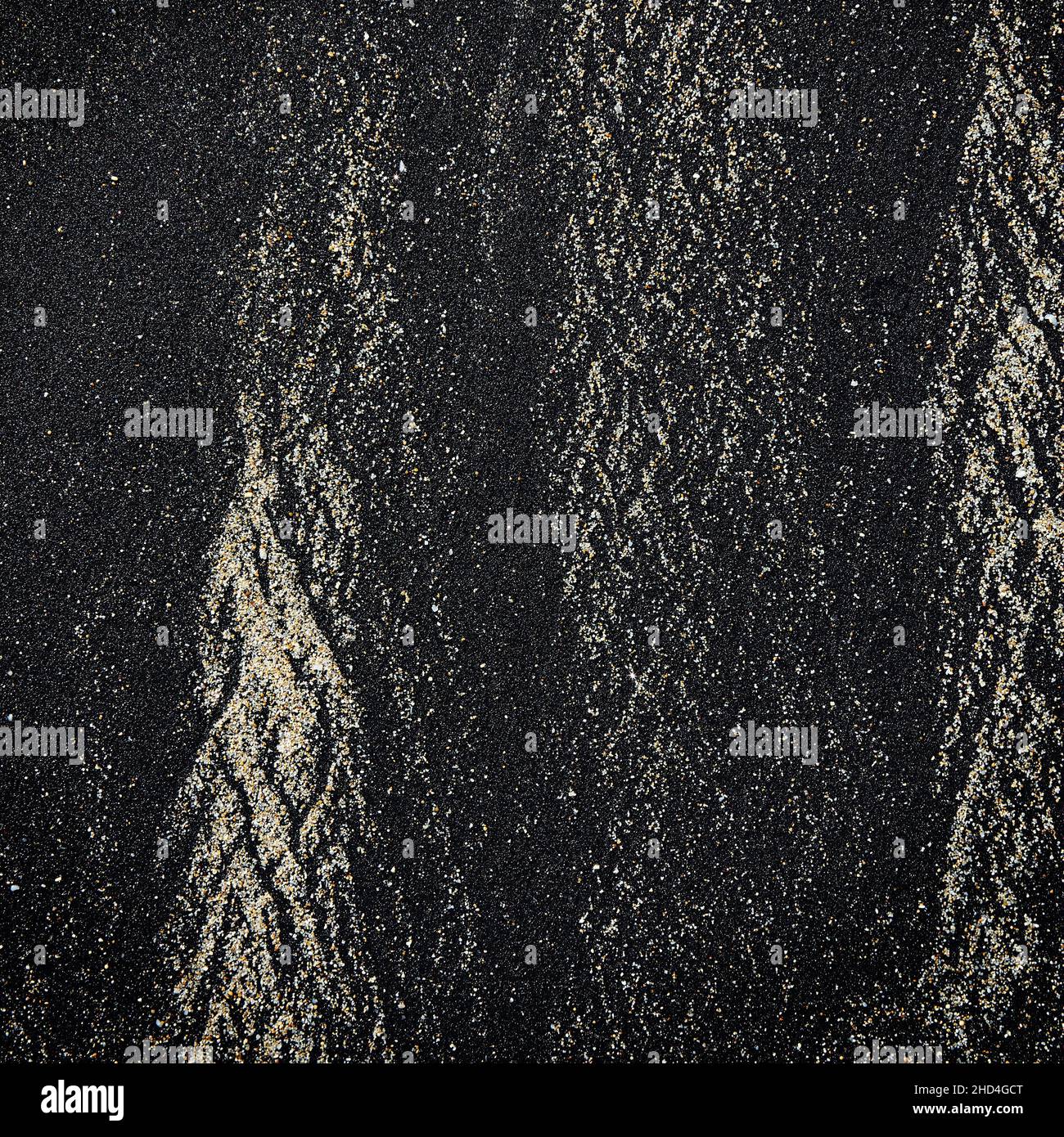 Abstract pattern made by waves on volcanic black sand of Bali island Stock Photo